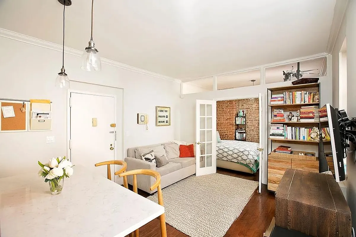 314 West 94th Street, Unit 5E Manhattan, NY 10025 - Photo 1 of 9 a living room with furniture and floor to ceiling window