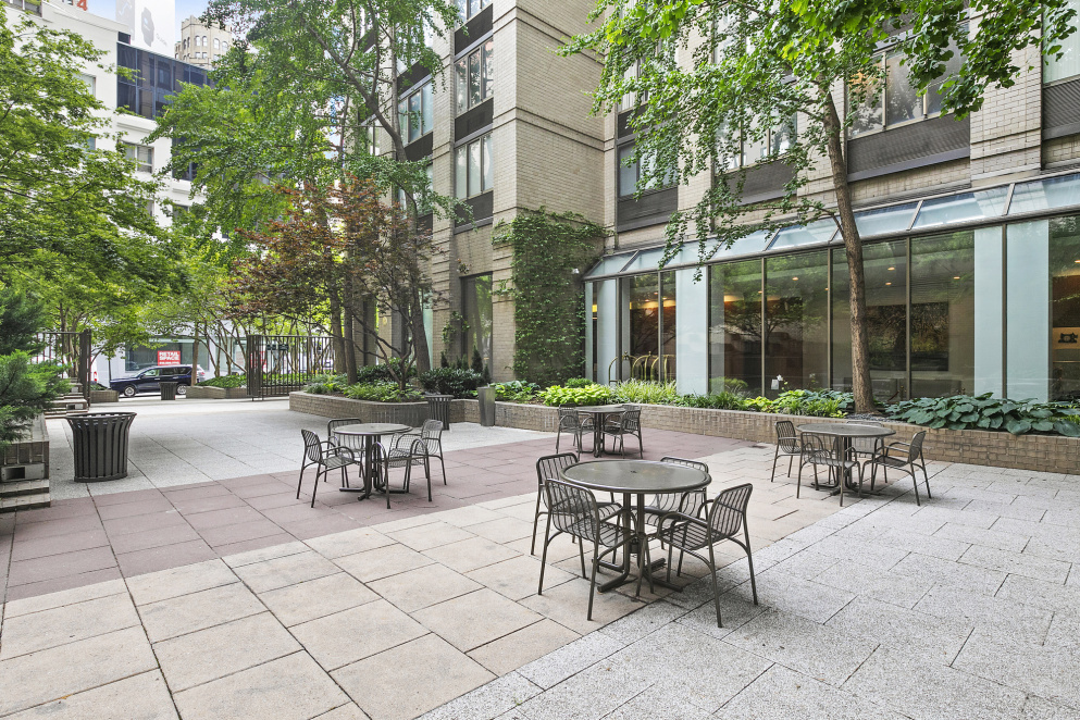 5 East 22nd Street, Unit 28M Manhattan, NY 10010 - Photo 9 of 11 a view of a patio with table and chairs and potted plants