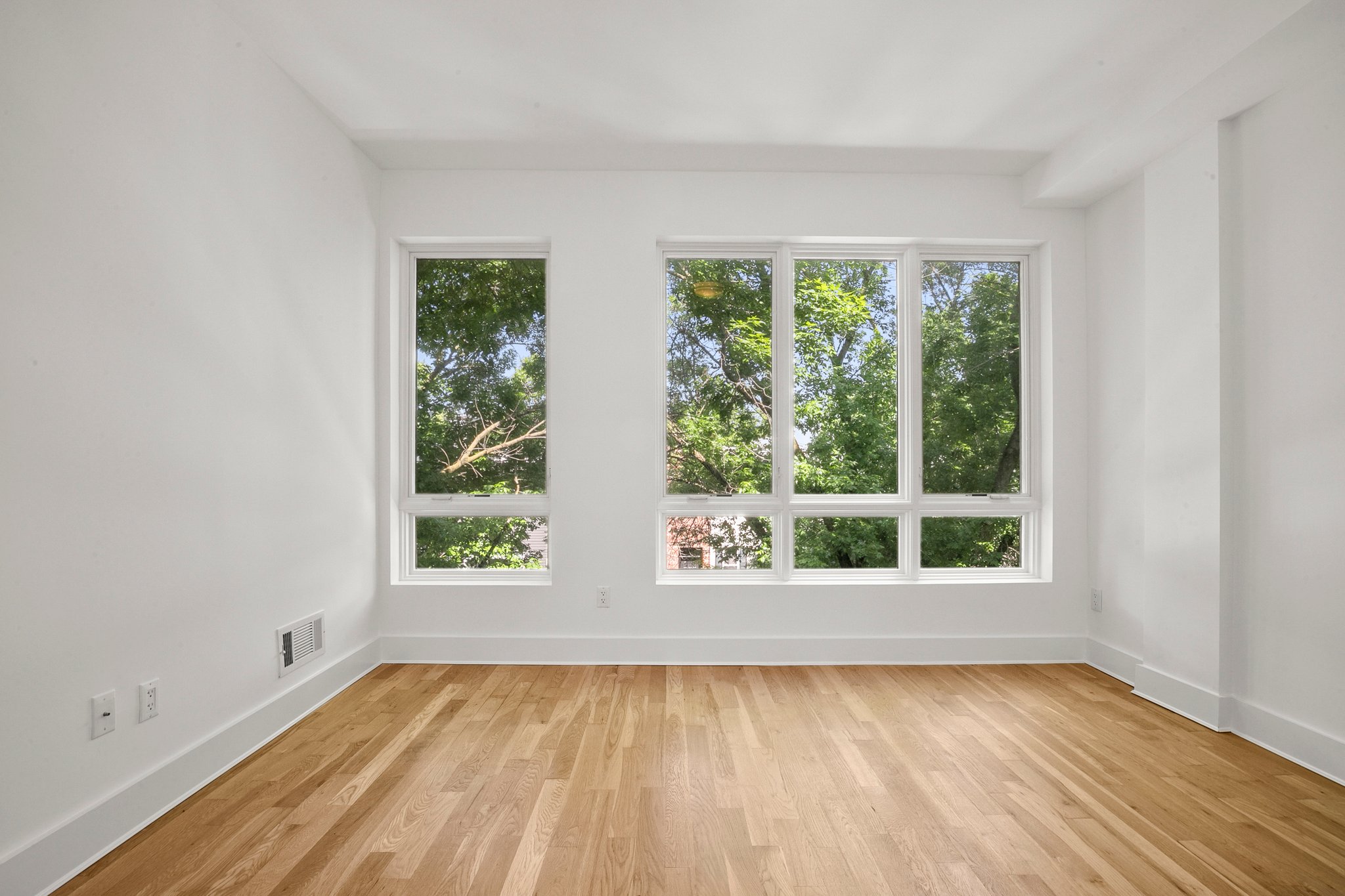 1130 Decatur Street Brooklyn, NY 11207 - Photo 5 of 24 a view of an empty room with wooden floor and a window