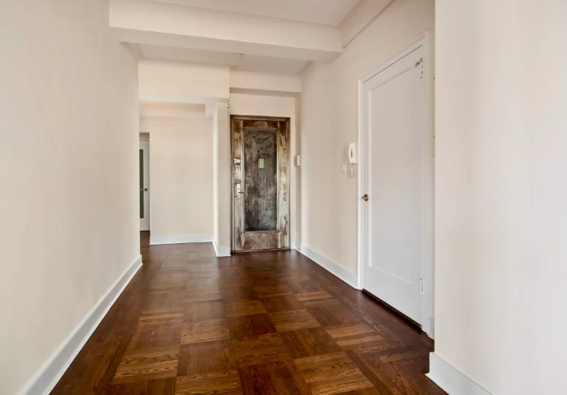56 7th Avenue, Unit 19H Manhattan, NY 10011 - Photo 5 of 12 a view of an empty room with wooden floor