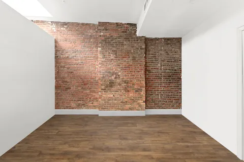 a spacious bedroom with a bed and a flat screen tv