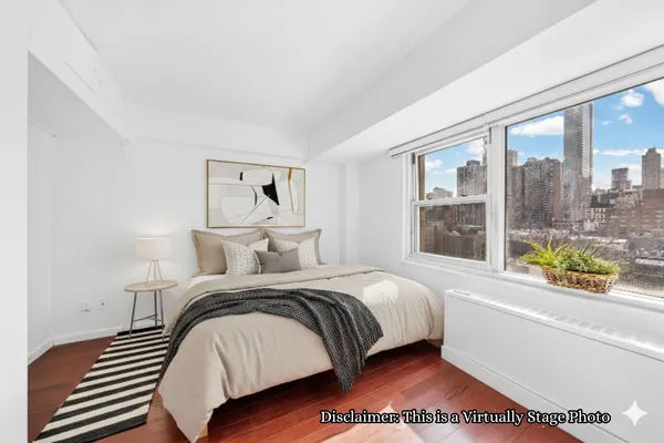 a bedroom with a bed and a large window