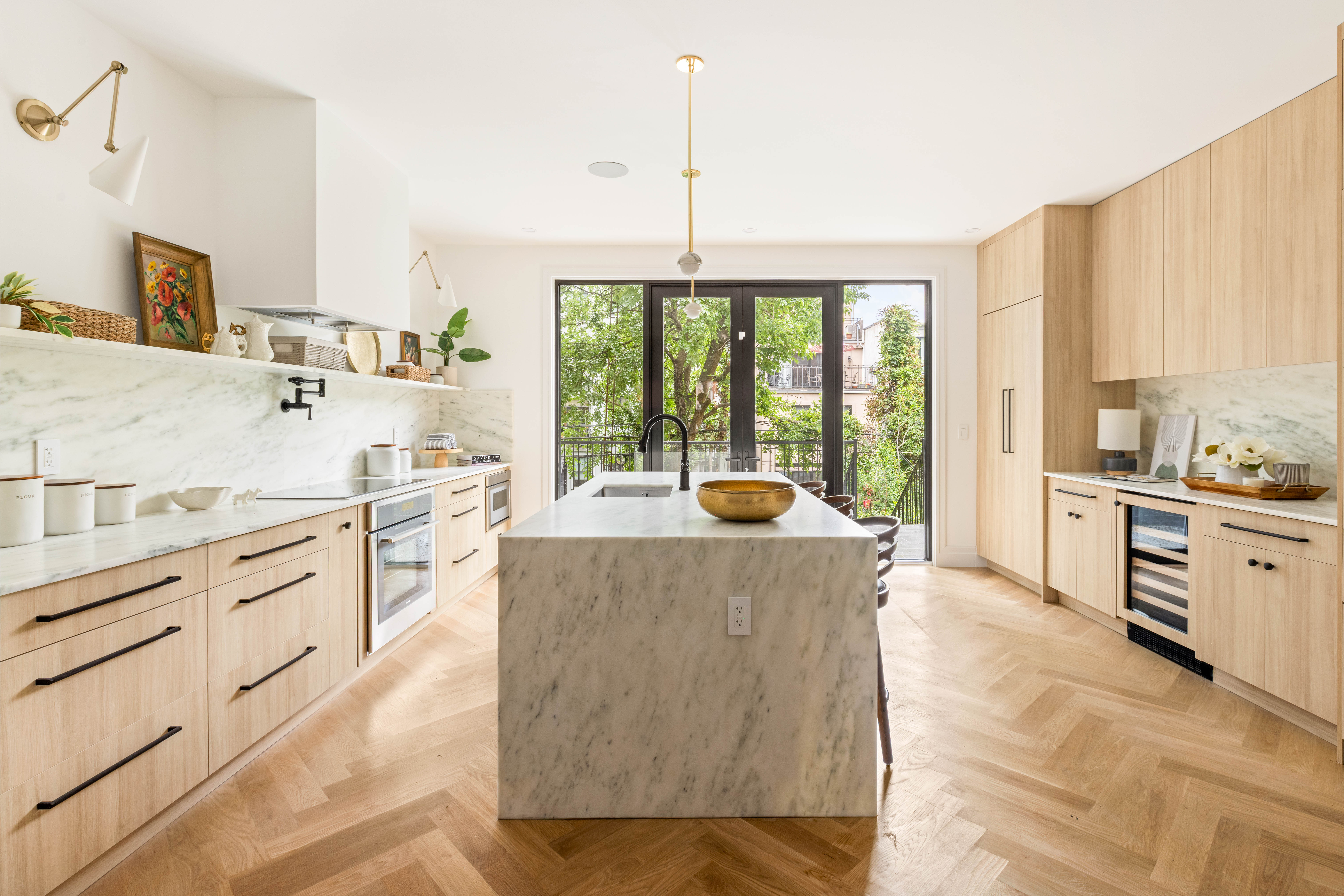 173 8th Street Brooklyn, NY 11215 - Photo 4 of 17 a large kitchen with kitchen island a large counter top space a sink a stove and a window