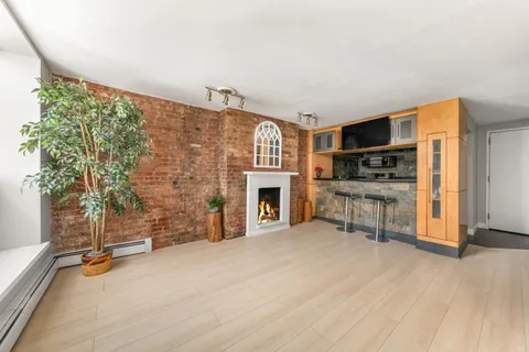 a view of a livingroom with furniture and a fireplace