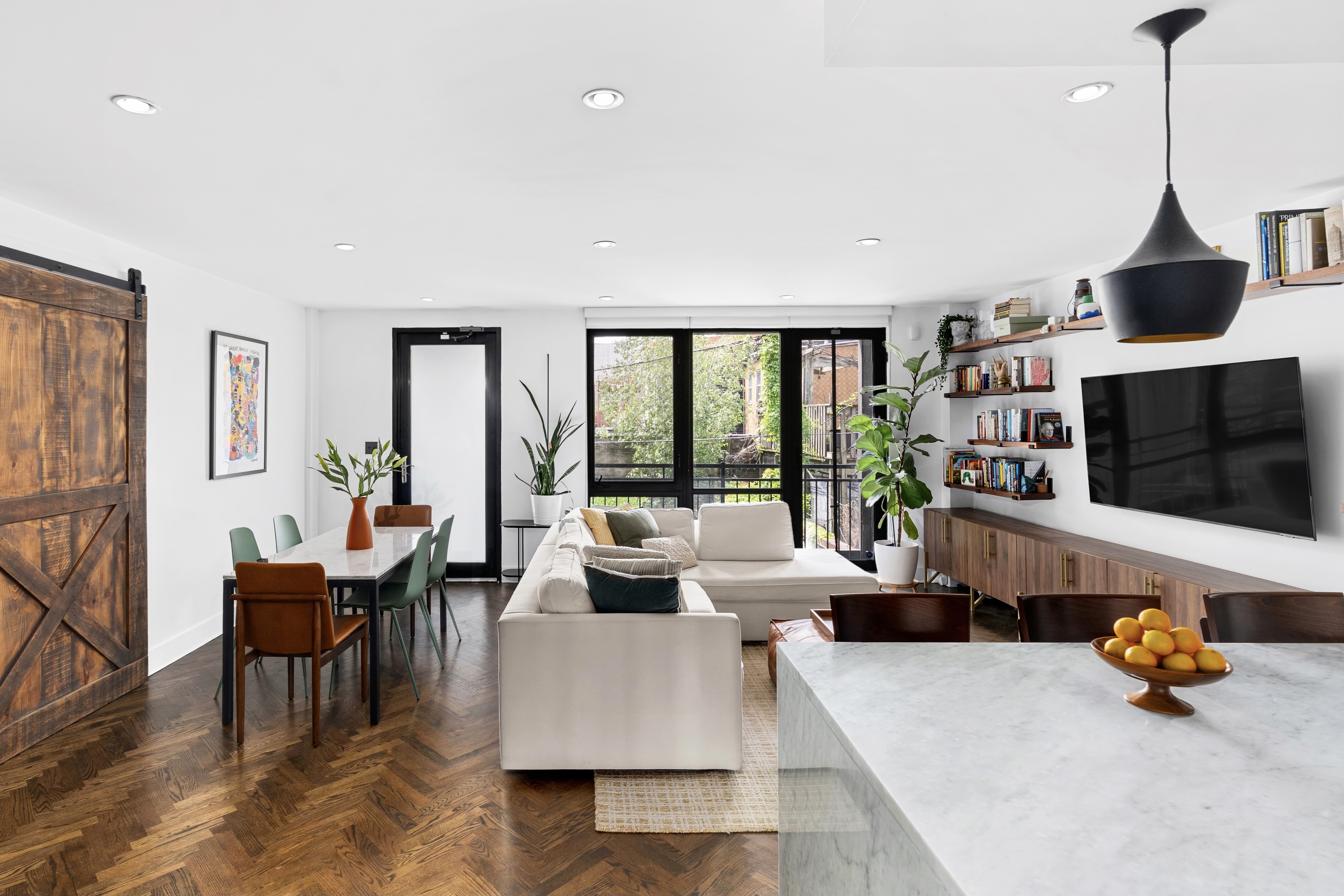 245 Manhattan Avenue, Unit 2A Brooklyn, NY 11211 - Photo 1 of 10 a living room with furniture and a flat screen tv