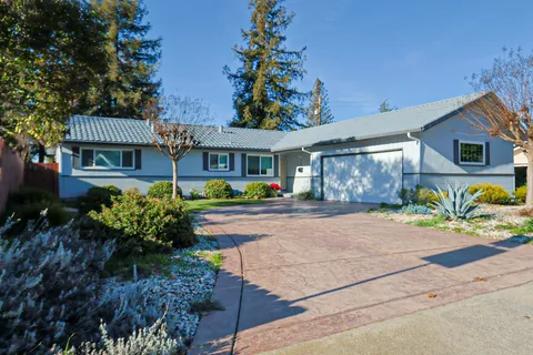 a front view of a house with garden