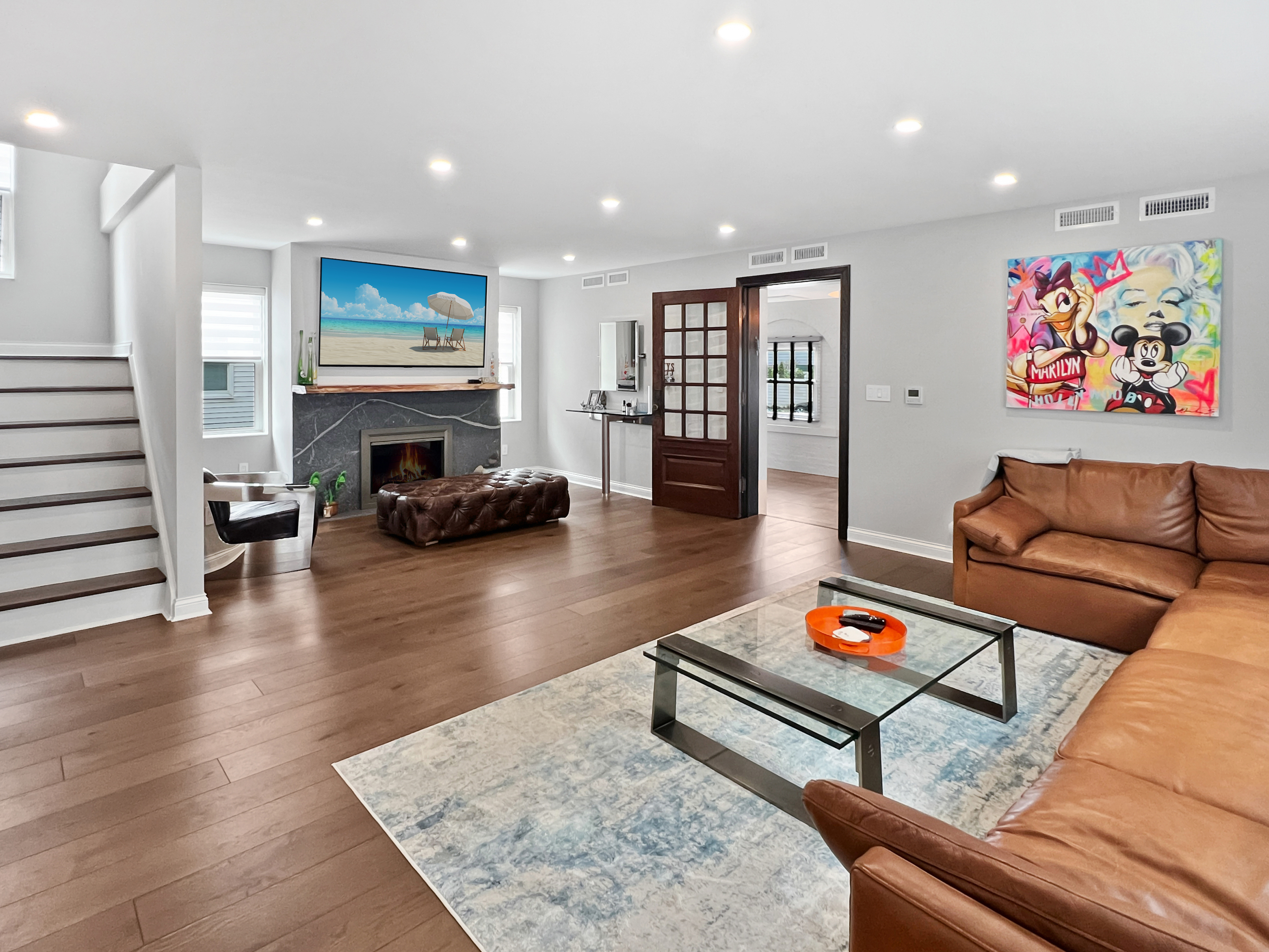 a living room with furniture and a wooden floor