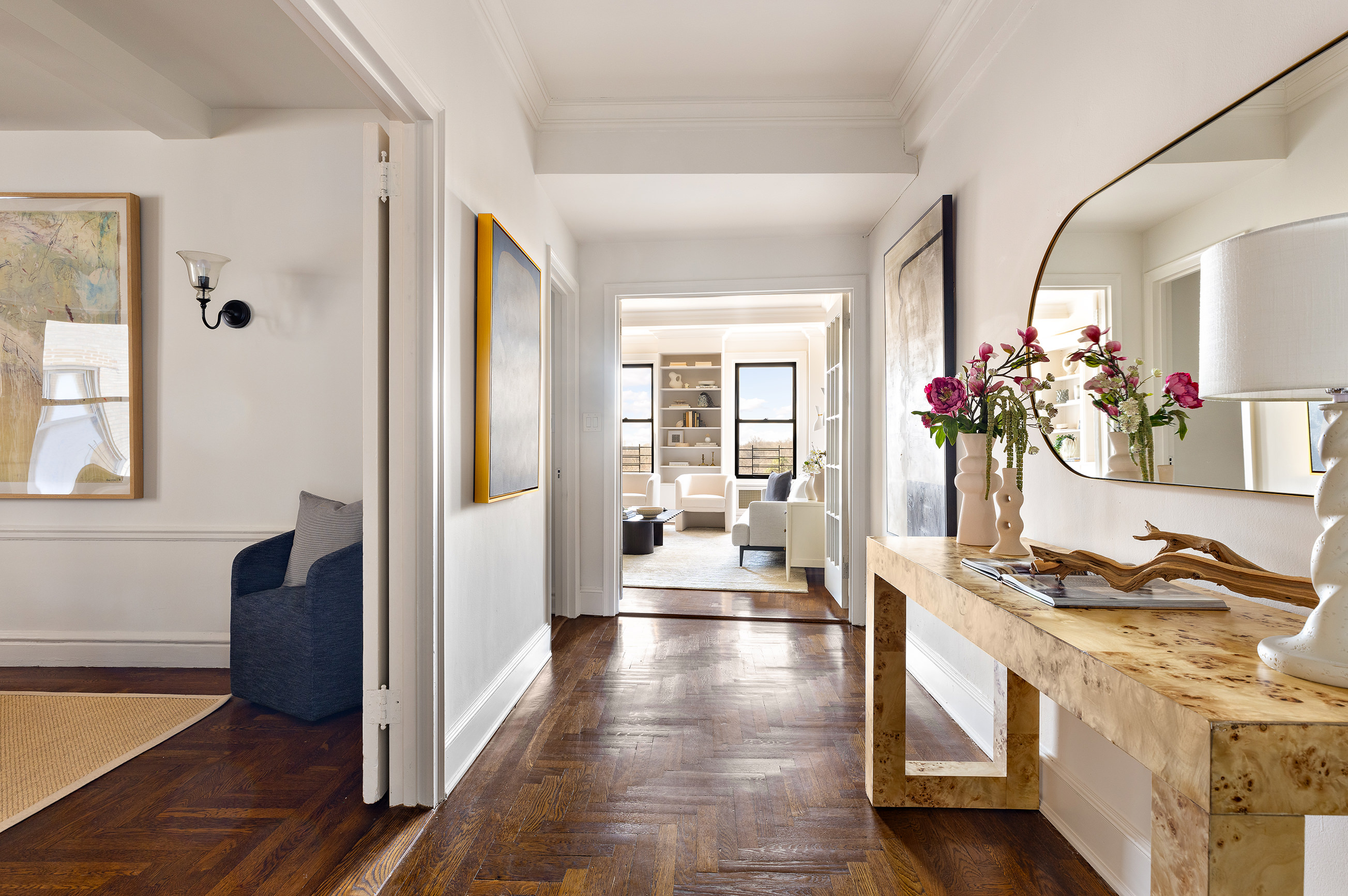 135 Eastern Parkway, Unit 7A Brooklyn, NY 11238 - Photo 3 of 15 a hallway with a dining table chairs and couches with wooden floor