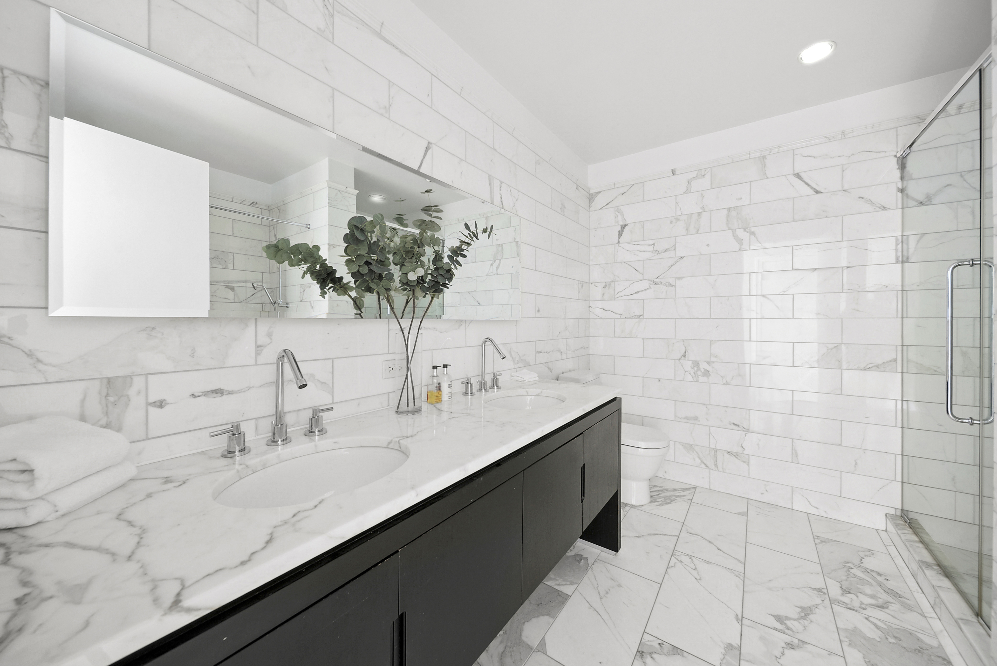 225 5th Avenue, Unit 7K Manhattan, NY 10010 - Photo 11 of 15 a bathroom with a sink and a mirror