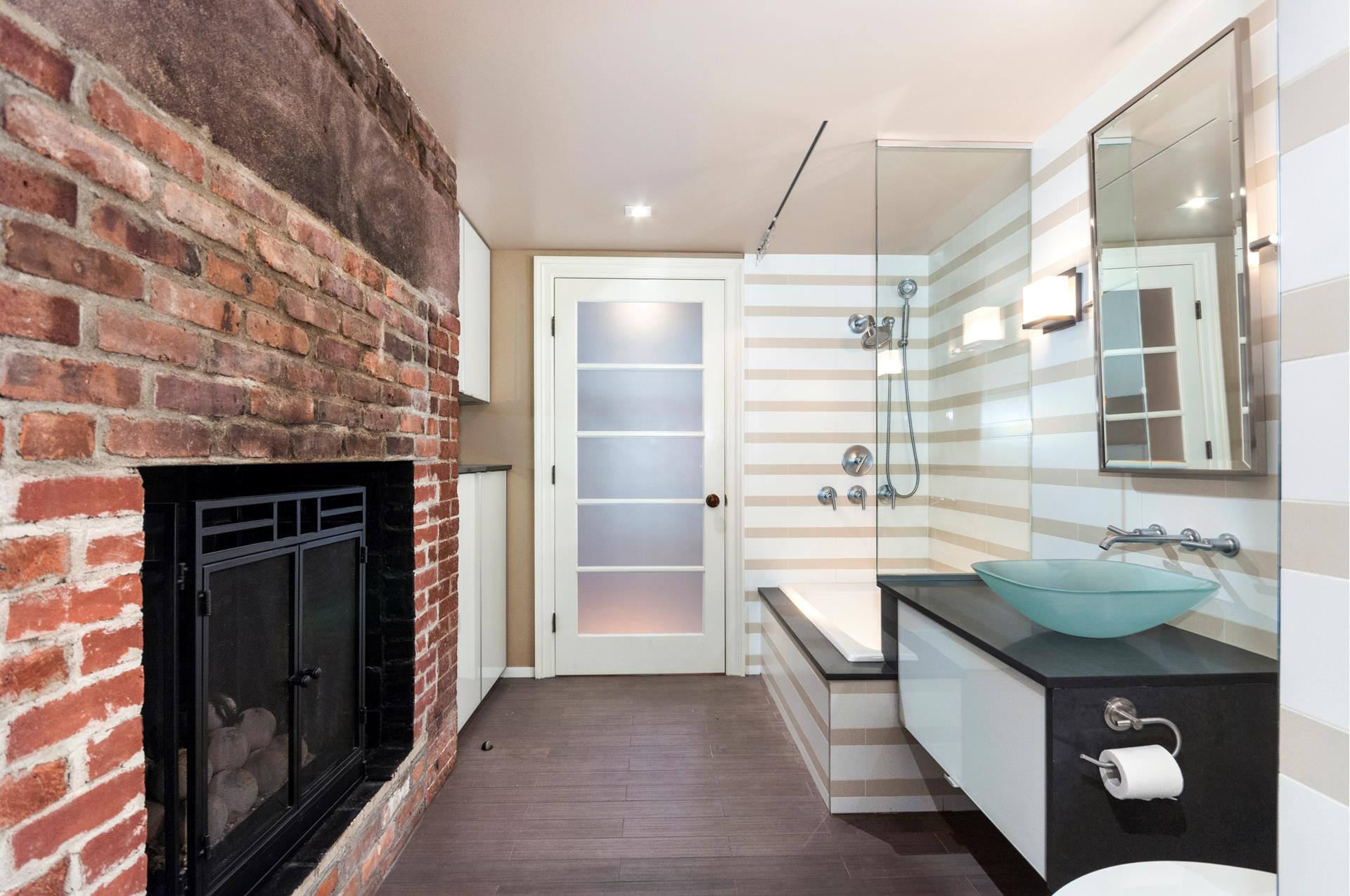 150 Dean Street, Unit 1 Brooklyn, NY 11217 - Photo 5 of 7 a bathroom with a granite countertop sink a toilet a shower and a mirror