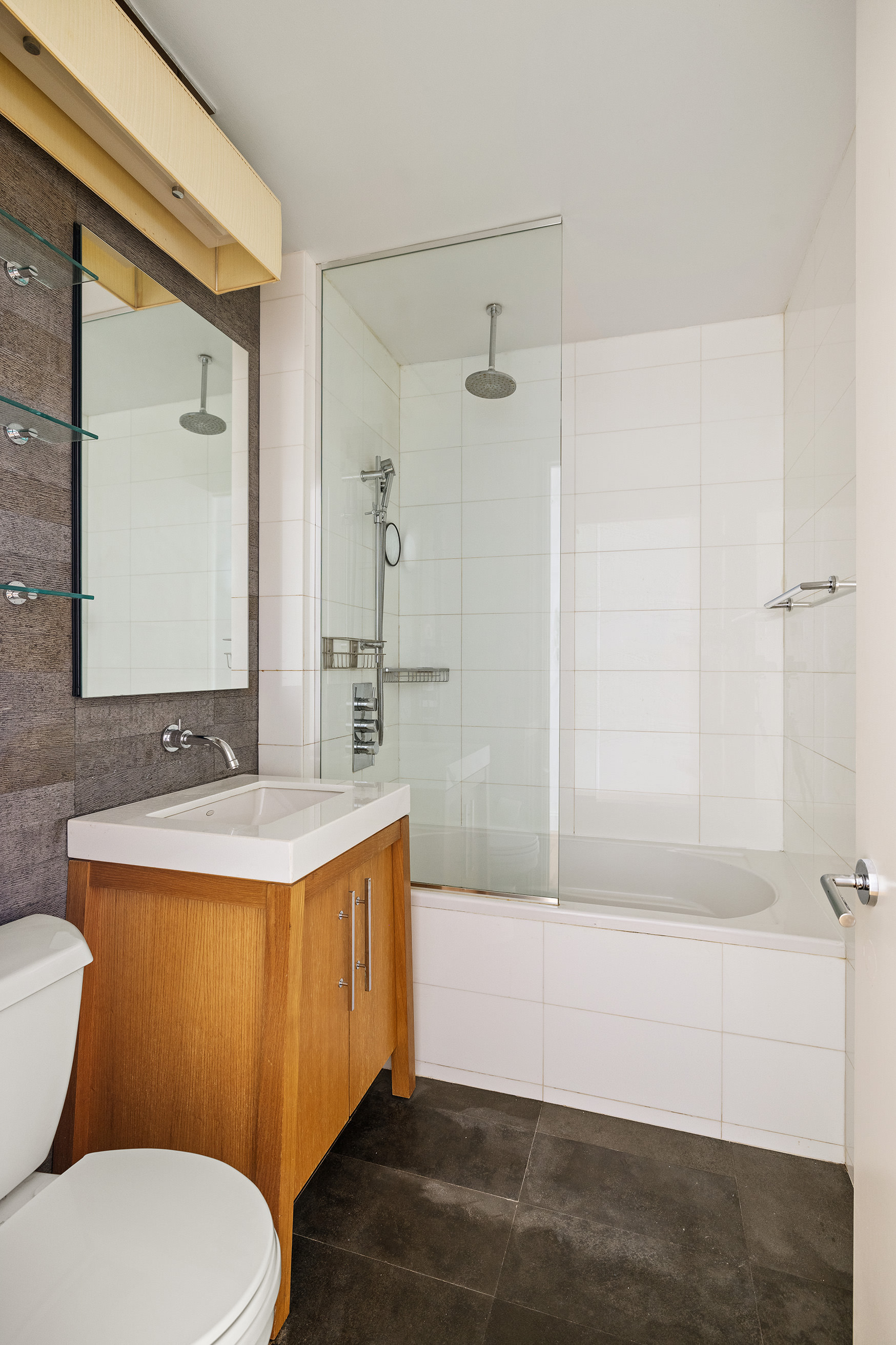 88 Greenwich Street, Unit 1014 Manhattan, NY 10006 - Photo 6 of 14 a bathroom with a sink a toilet and shower