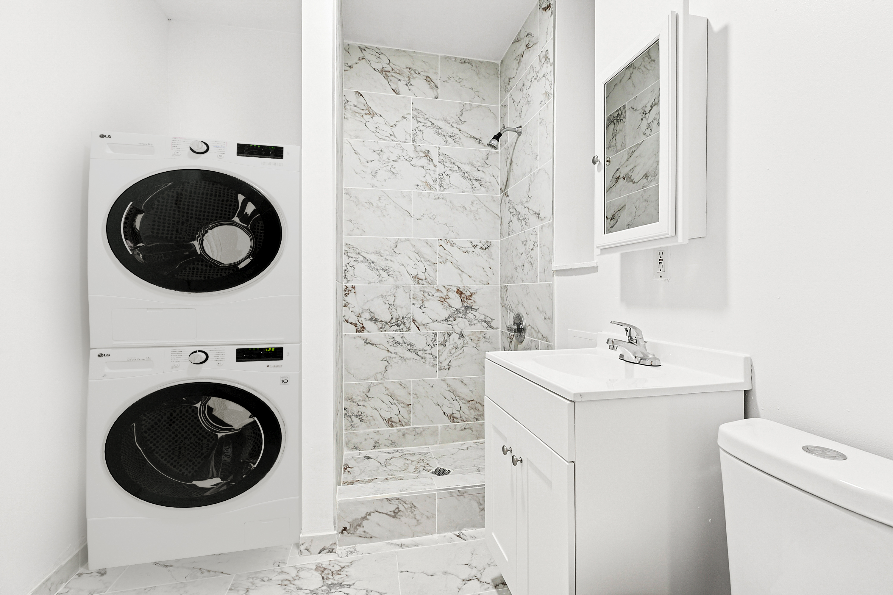 205 West 20th Street, Unit 1A Manhattan, NY 10011 - Photo 6 of 7 a utility room with dryer and washer