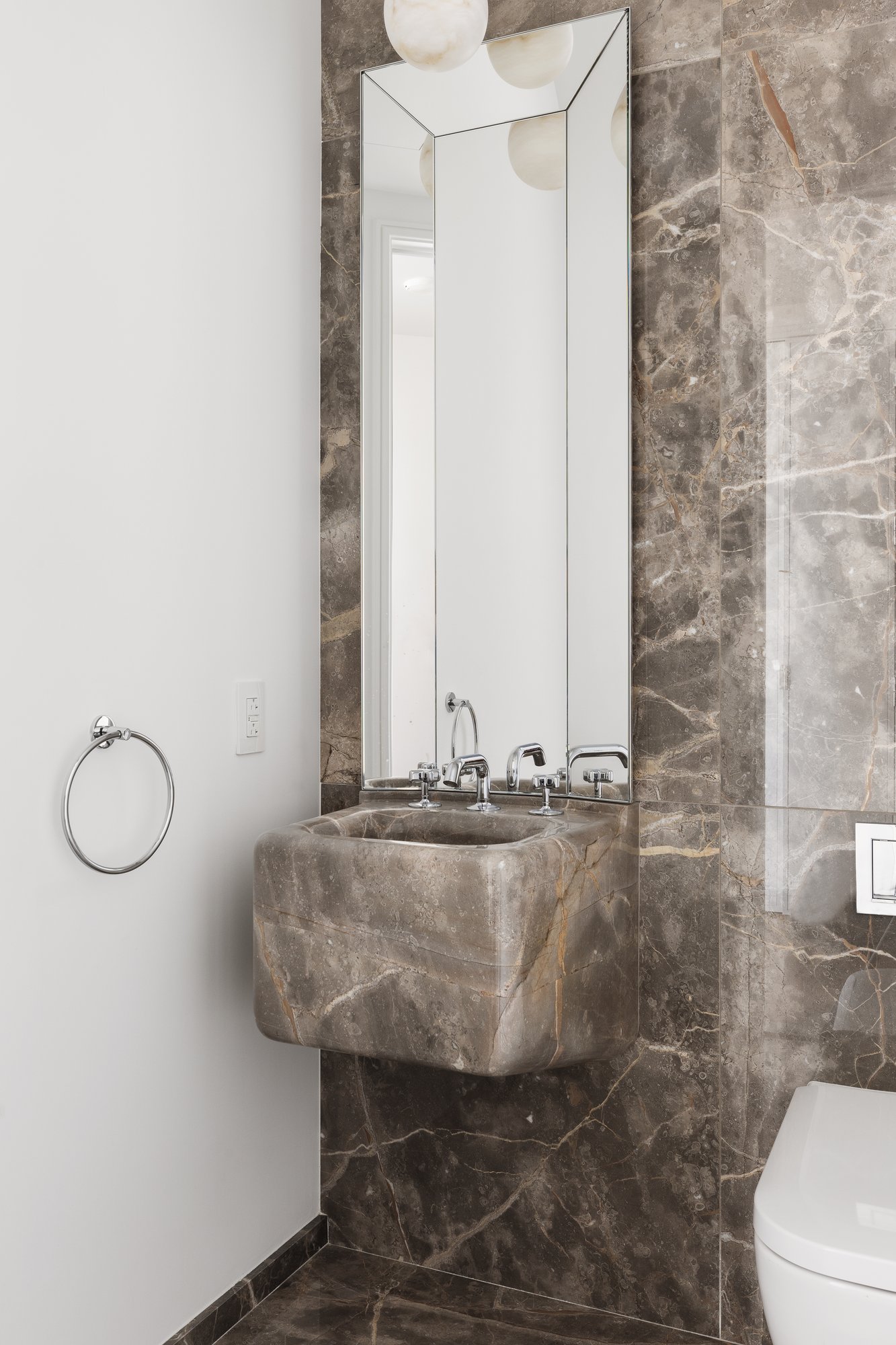 430 East 58th Street, Unit 39A Manhattan, NY 10022 - Photo 6 of 15 a bathroom with a granite countertop sink and a mirror