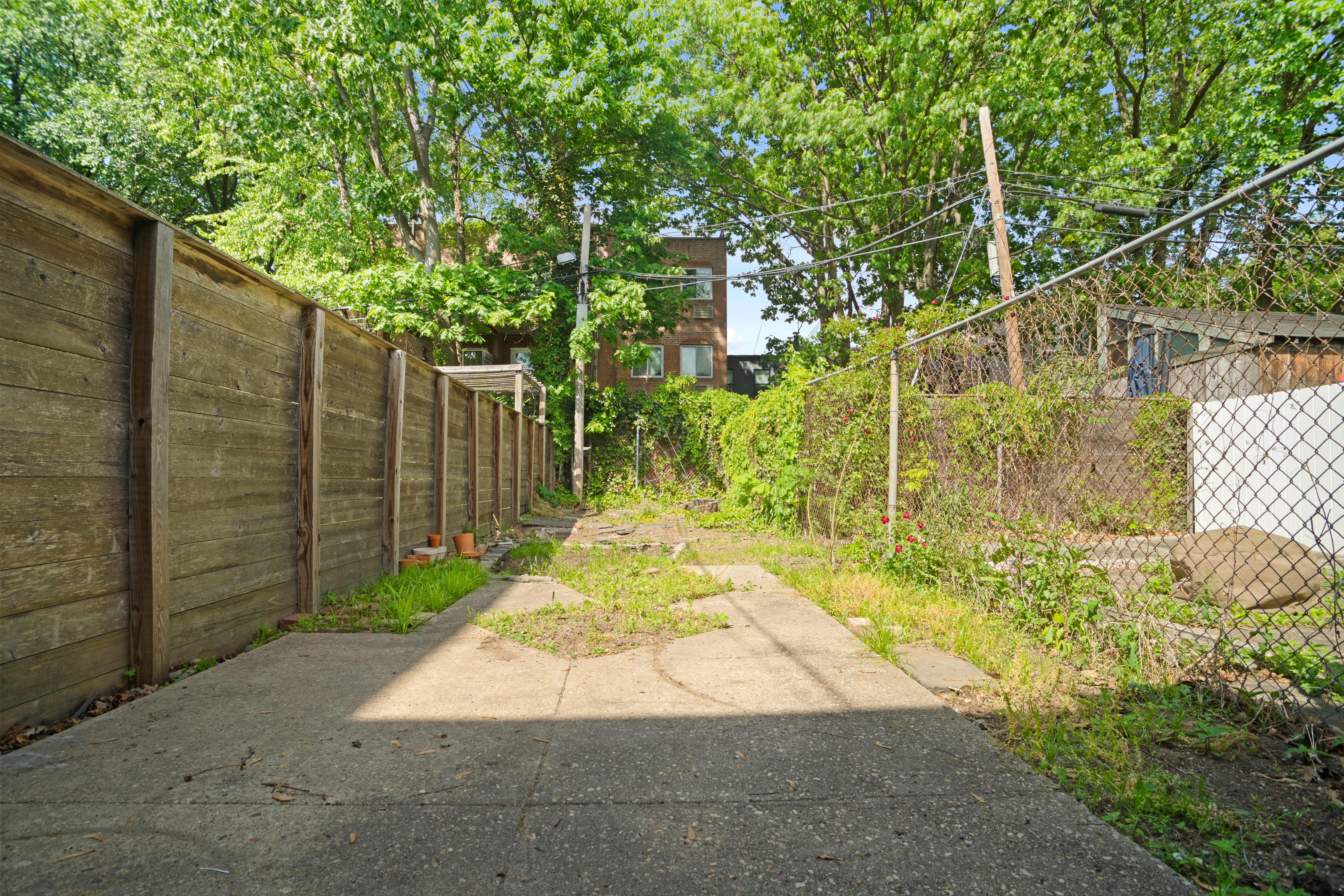 417 A 18th Street Brooklyn, NY 11215 - Photo 13 of 16 a view of a yard with plants and wooden fence