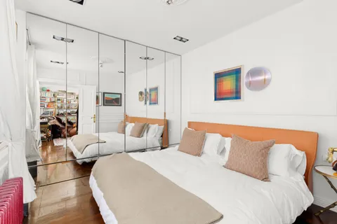 a bedroom with a bed and a couch