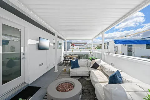 a living room with furniture and a kitchen view