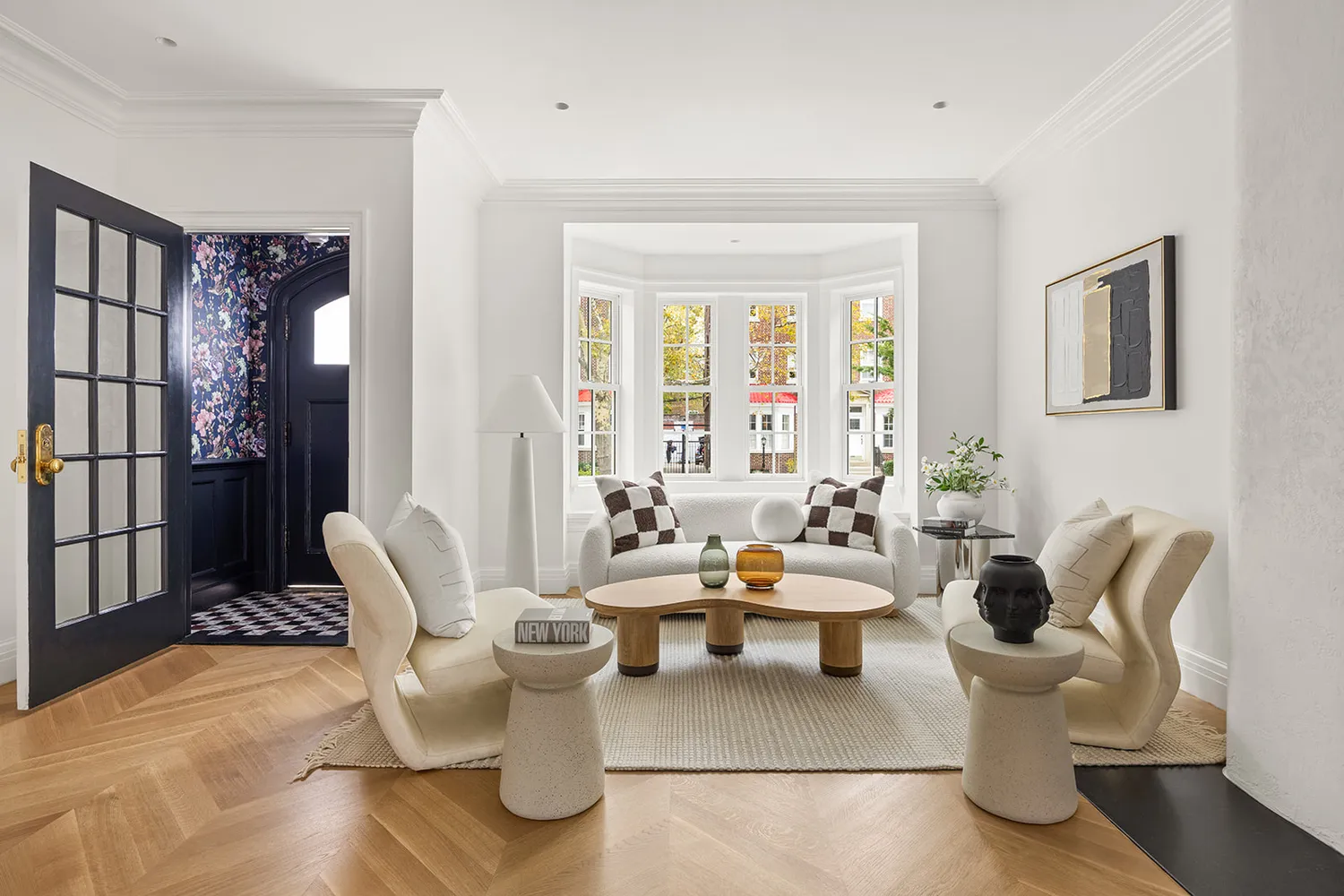 a living room with furniture and floor to ceiling windows
