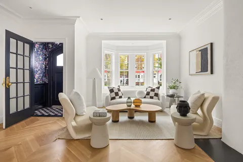 a living room with furniture and floor to ceiling windows