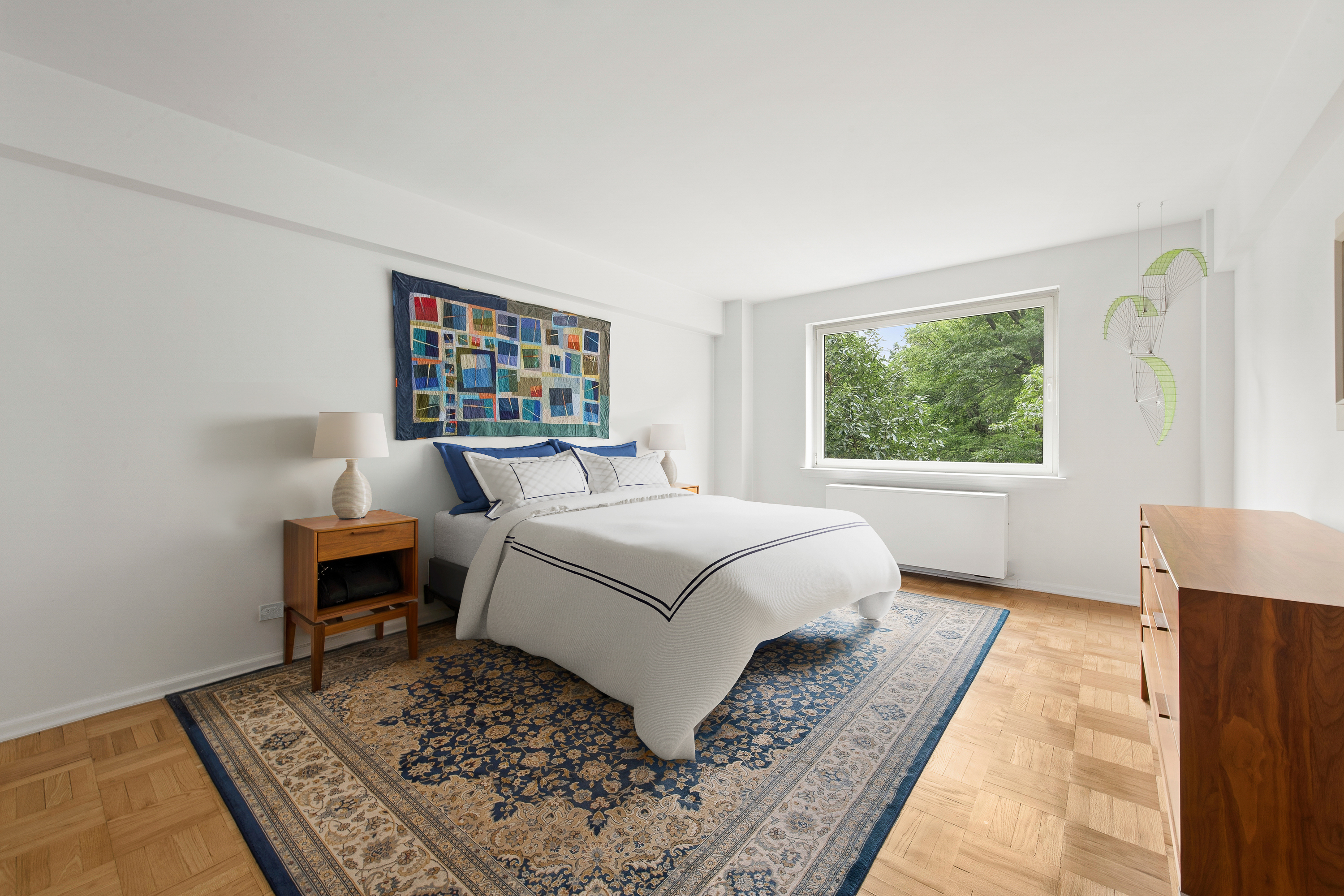 860 5th Avenue, Unit 3H Manhattan, NY 10065 - Photo 5 of 17 a bedroom with a large bed next to a window with a rug