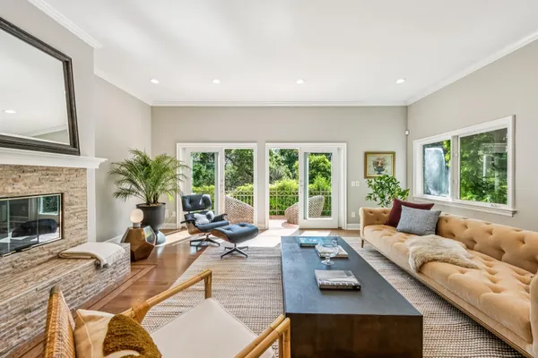 a living room with furniture large window and a fireplace