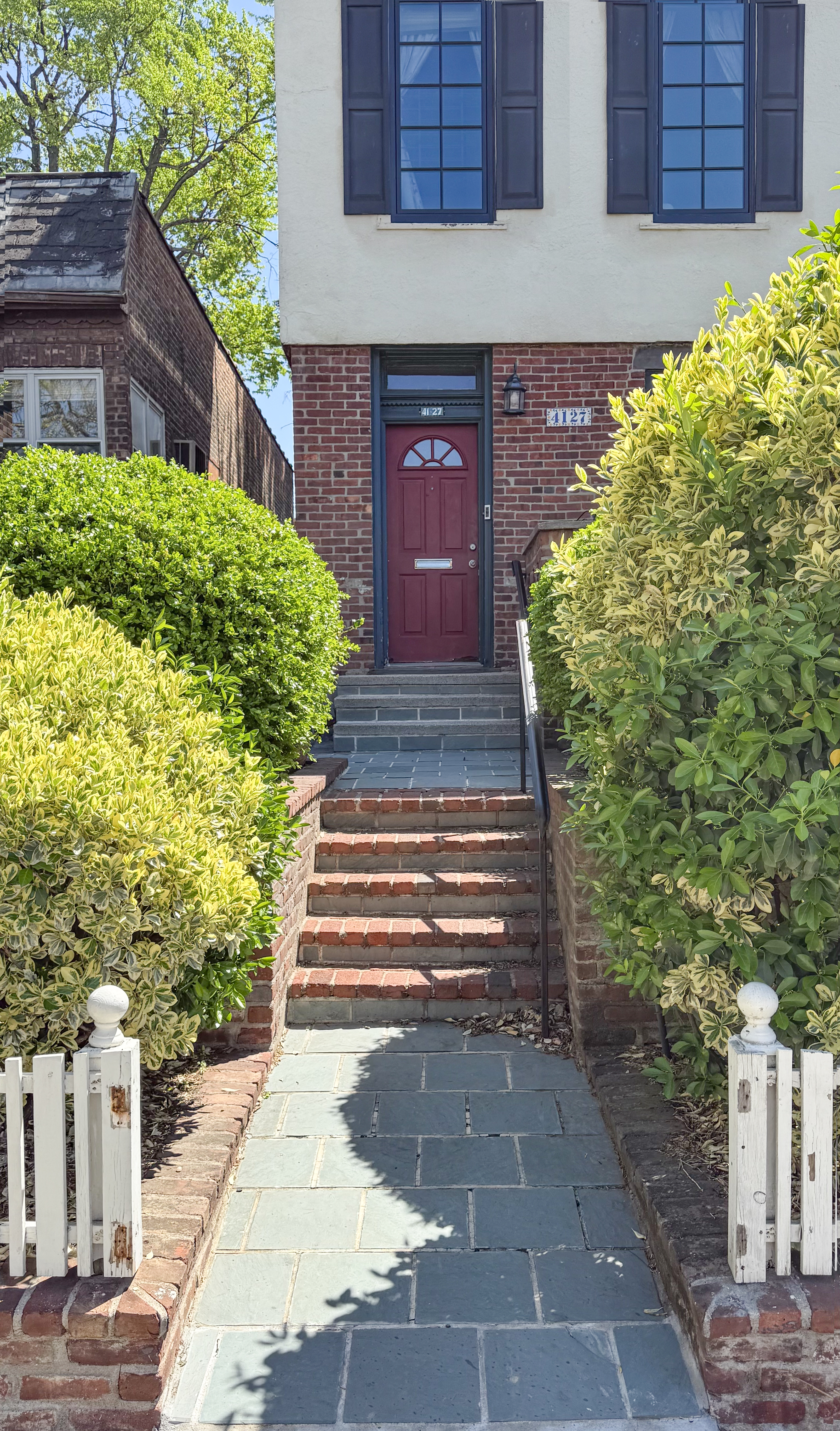 41-27 39th Place Queens, NY 11104 - Photo 12 of 13 a front view of a house with a yard and plants