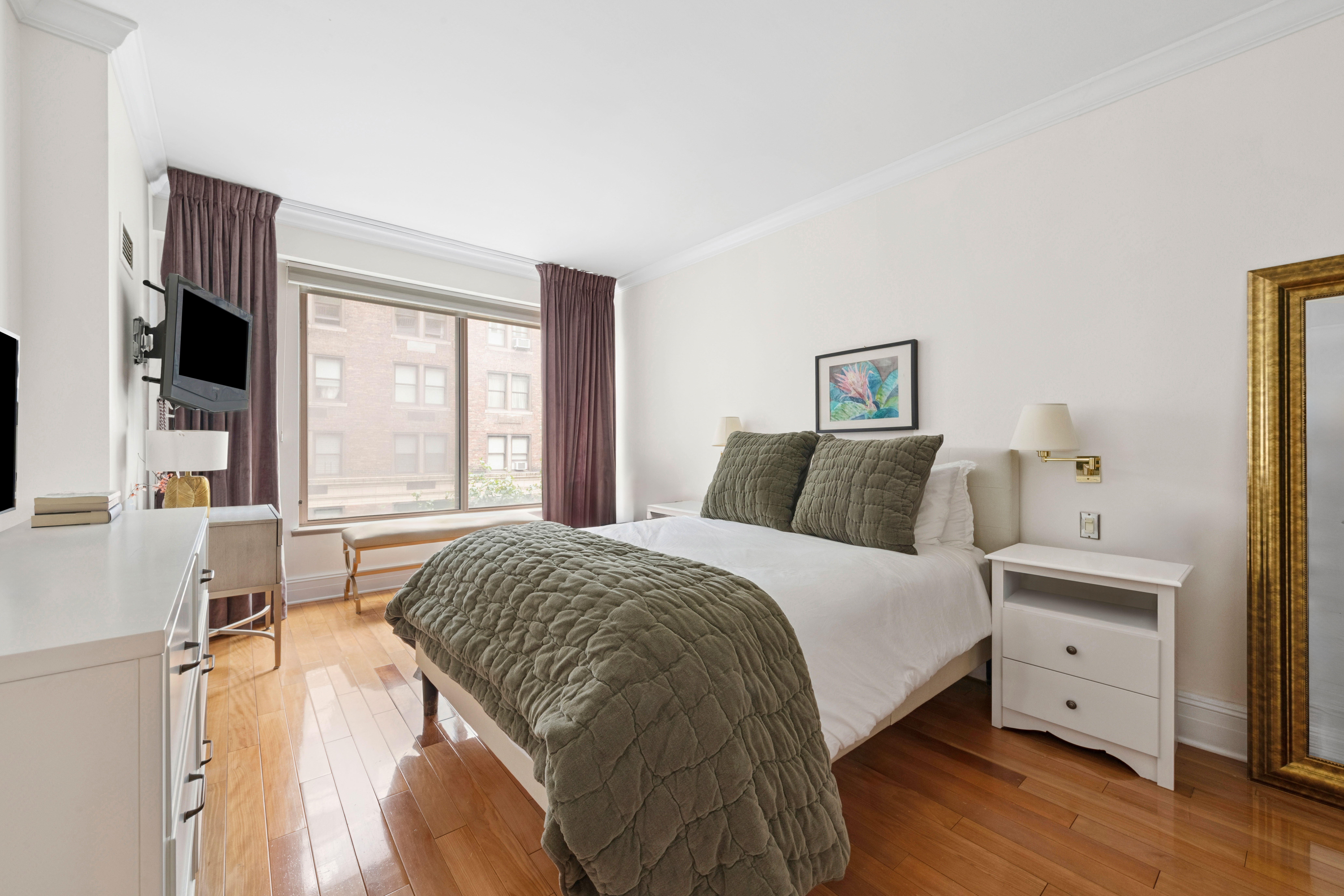 200 East 69th Street, Unit 4N Manhattan, NY 10021 - Photo 3 of 13 a bedroom with a bed and a flat screen tv