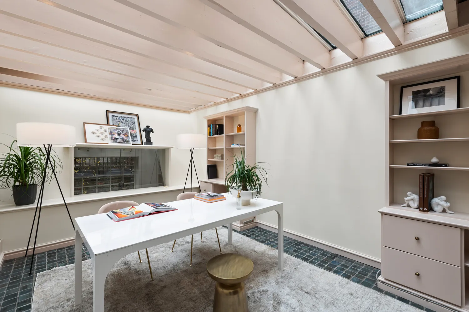 a room with furniture a rug and a potted plant