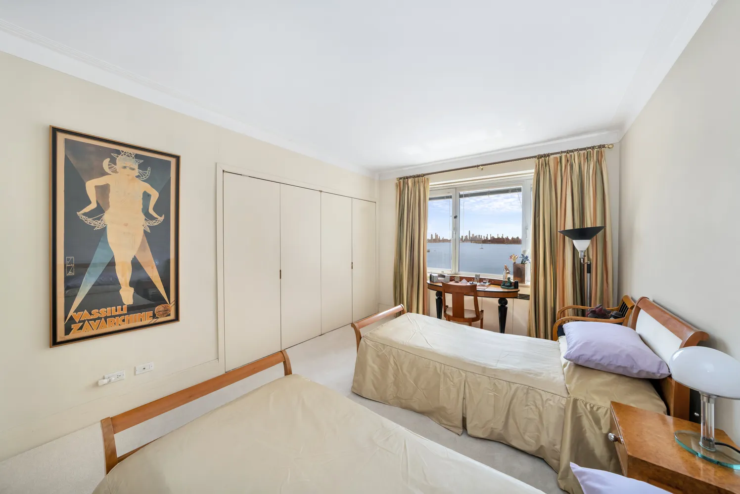 a bedroom with furniture and a large window