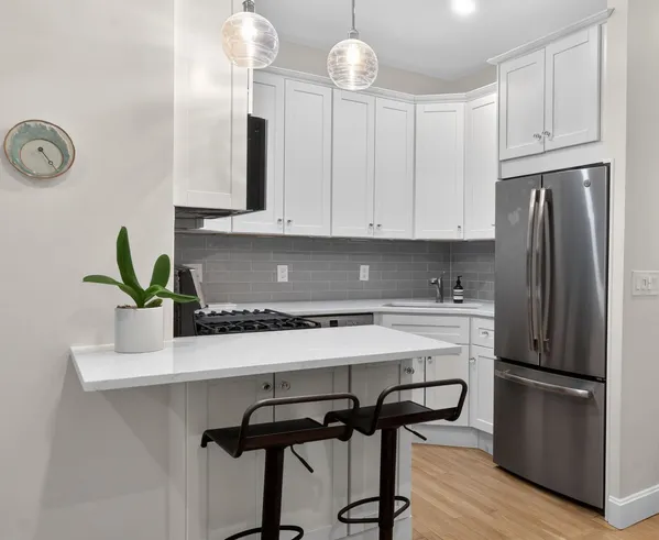 a kitchen with appliances cabinets and a counter top space