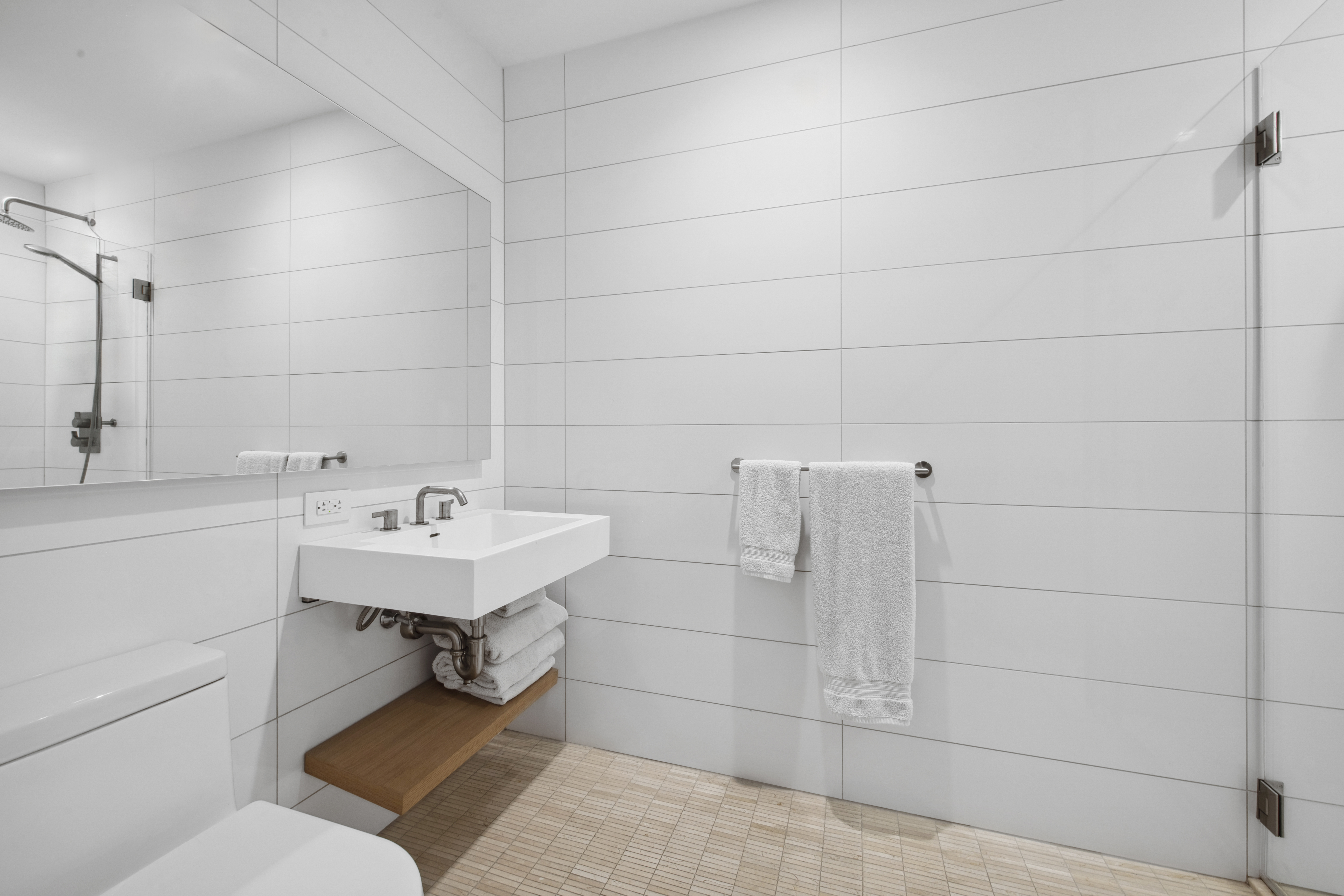 98 Front Street, Unit 9S Brooklyn, NY 11201 - Photo 6 of 7 a bathroom with a sink toilet and shower