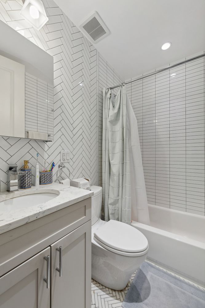 51 West 11th Street, Unit 3F Manhattan, NY 10011 - Photo 6 of 6 a bathroom with a sink a toilet and a bathtub