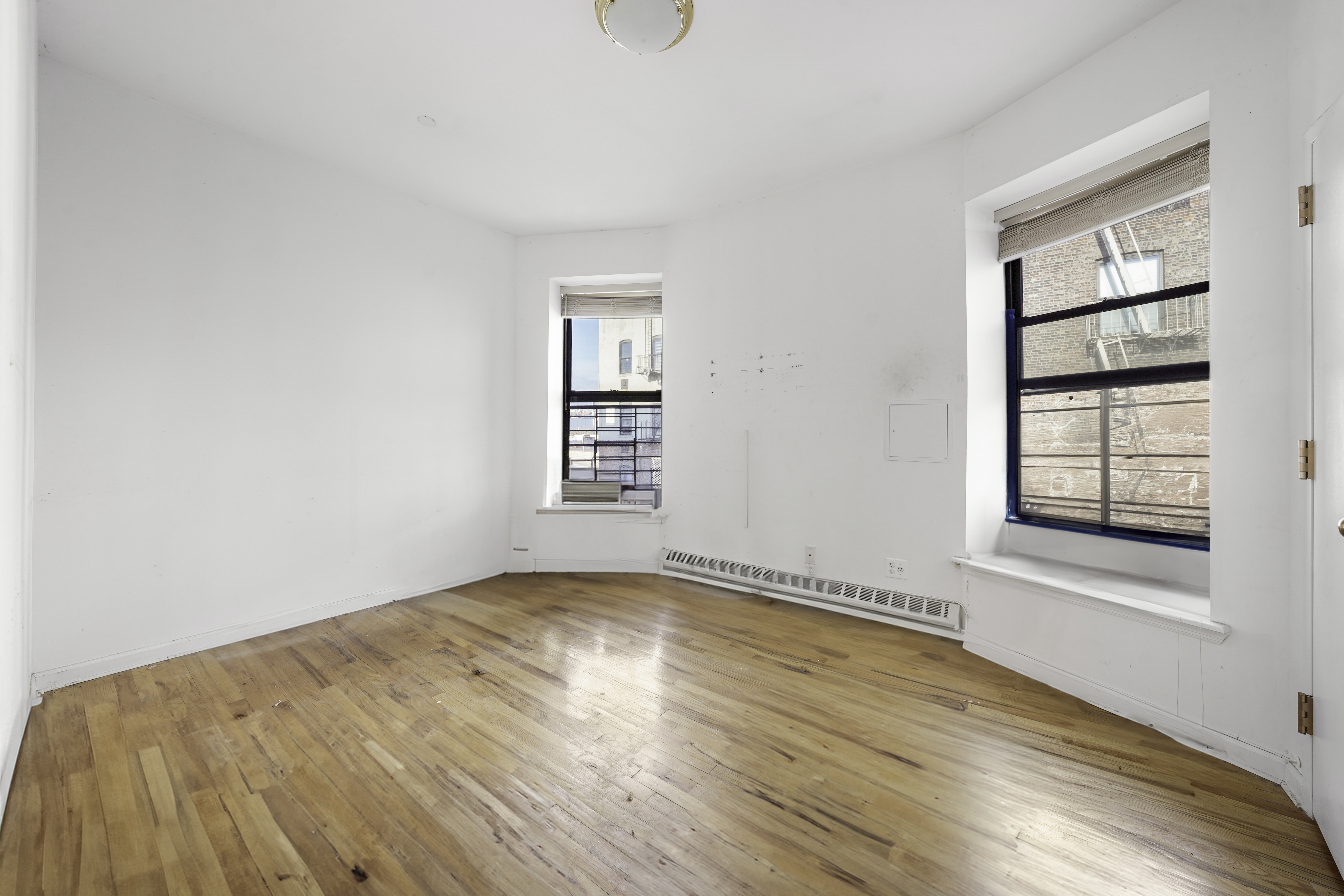 163 Lenox Avenue, Unit 5A Manhattan, NY 10026 - Photo 9 of 16 an empty room with windows