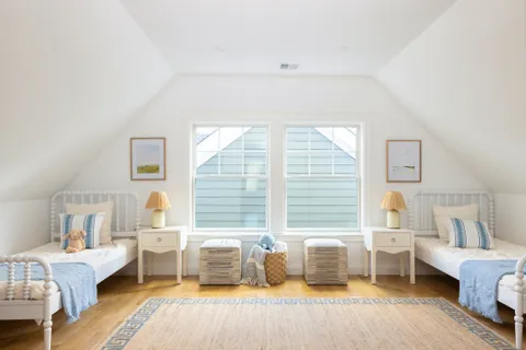 a bedroom with a large bed couch and a window