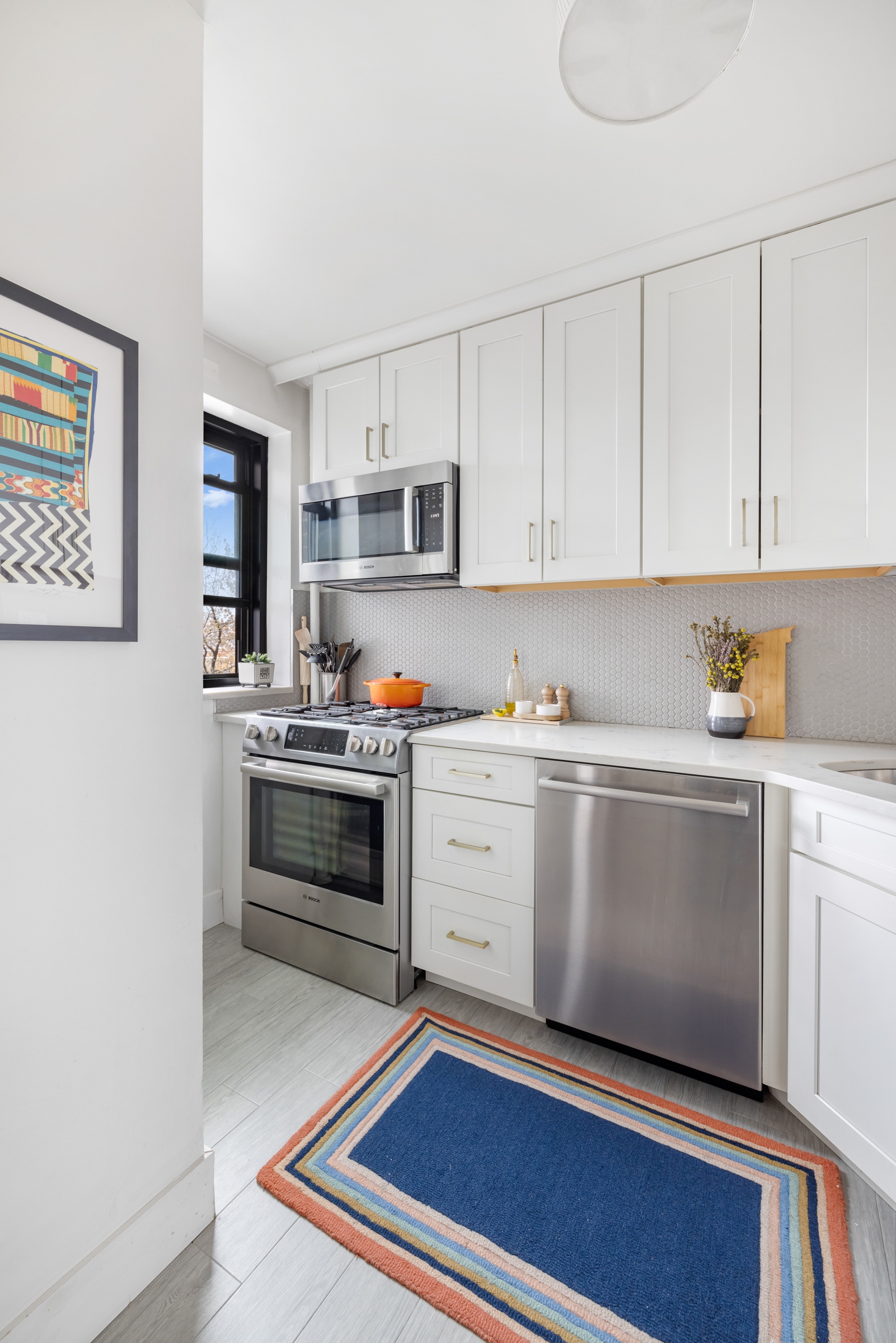 325 Clinton Avenue, Unit 7A Brooklyn, NY 11205 - Photo 6 of 13 a kitchen with granite countertop white cabinets and white appliances