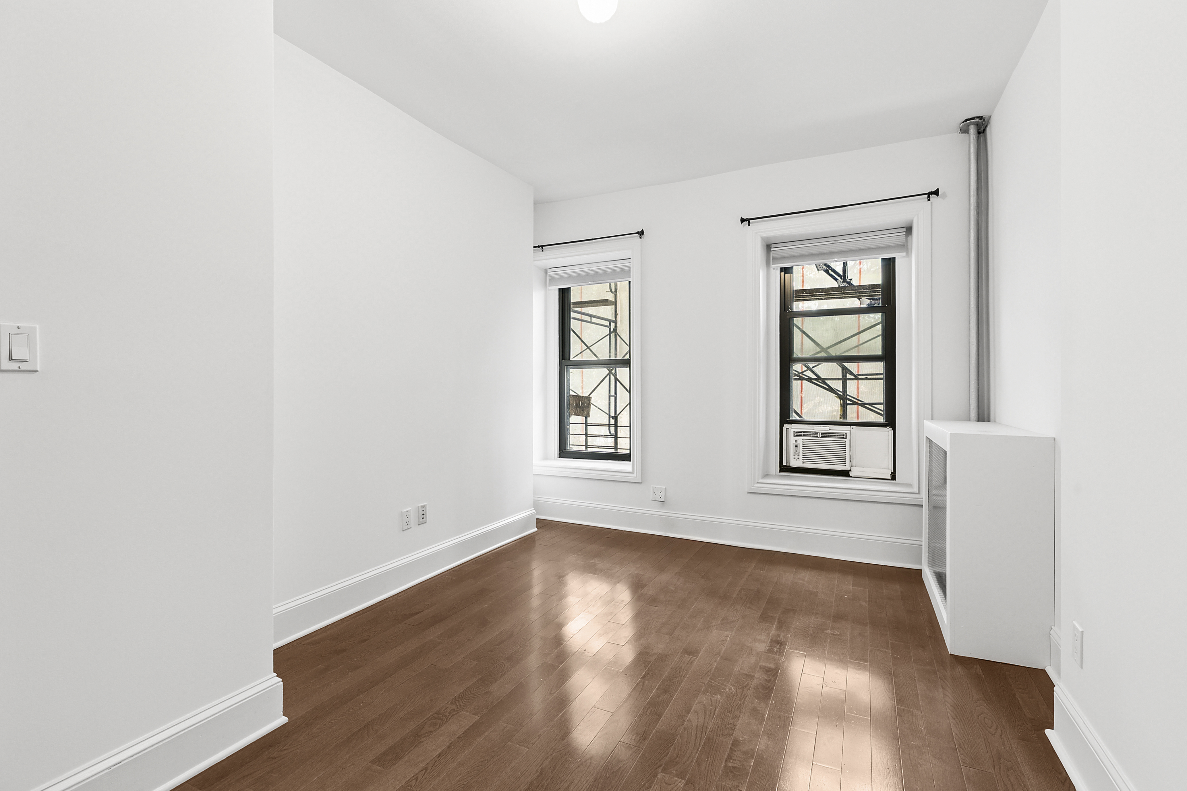 68 Downing Street, Unit 2 Brooklyn, NY 11238 - Photo 7 of 8 an empty room with wooden floor and windows