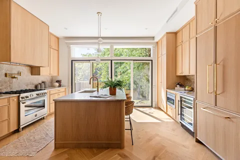a kitchen with stainless steel appliances granite countertop a stove a sink and a refrigerator