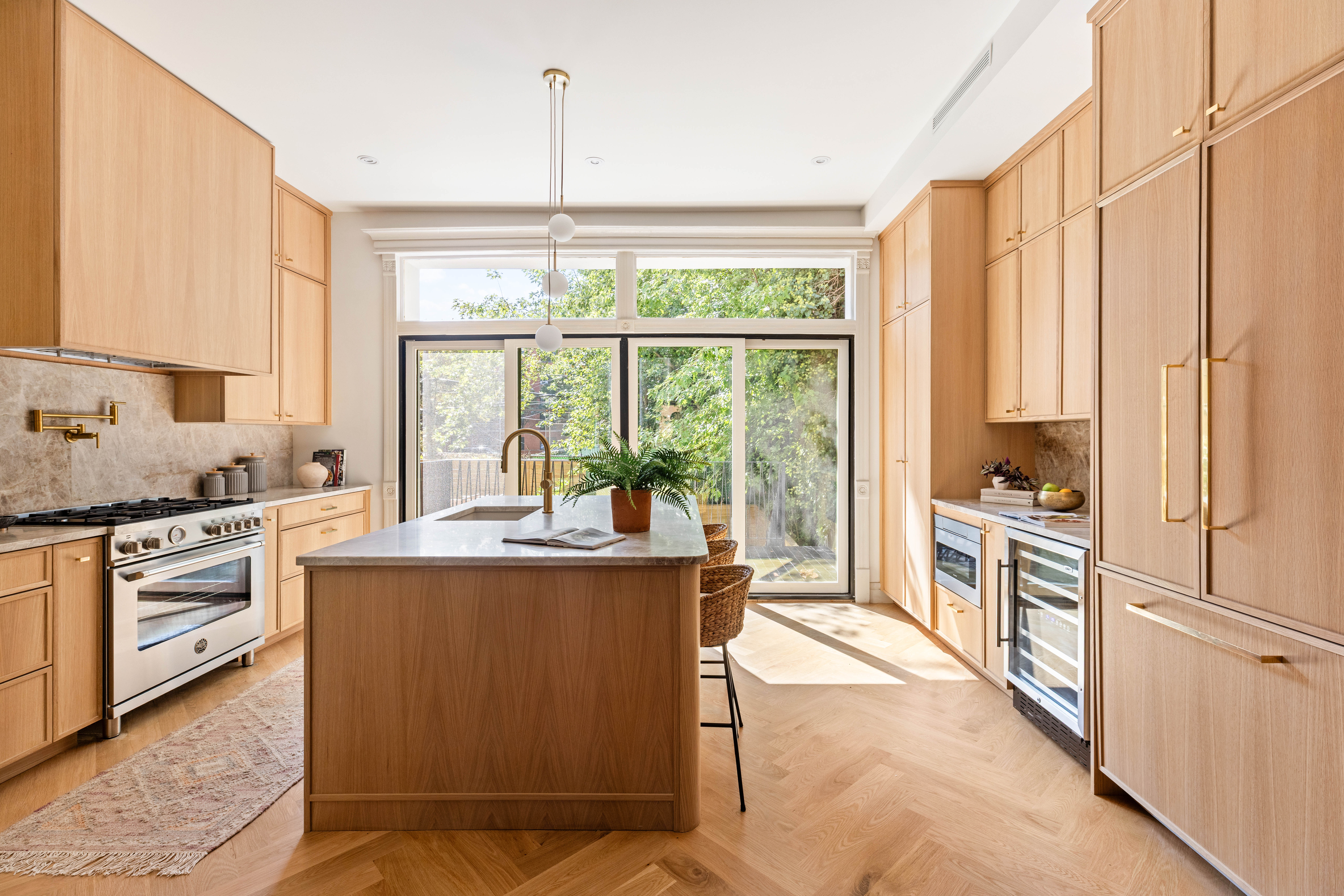 444 Quincy Street Brooklyn, NY 11221 - Photo 4 of 16 a kitchen with stainless steel appliances granite countertop a stove a sink and a refrigerator