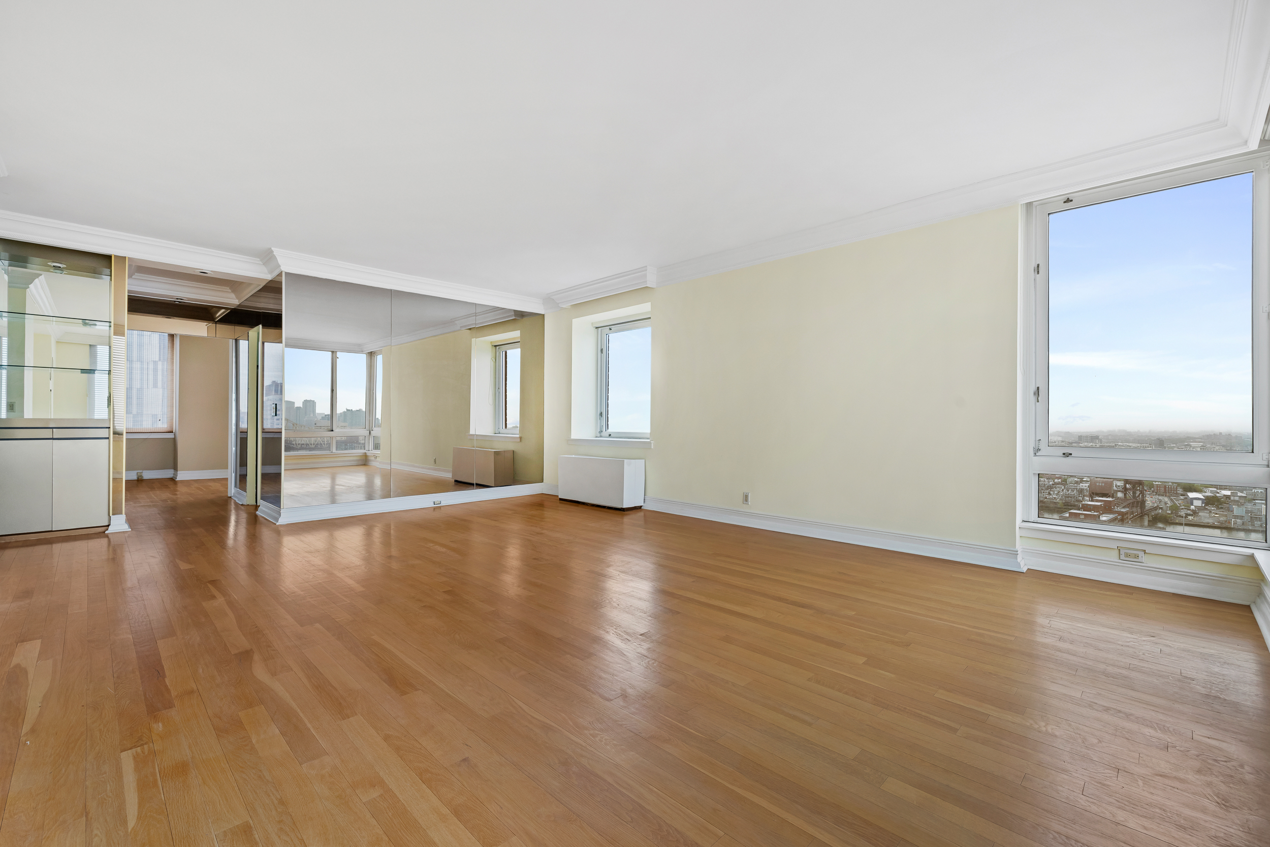524 East 72nd Street, Unit 31AG Manhattan, NY 10021 - Photo 5 of 17 a view of an empty room with wooden floor and a window