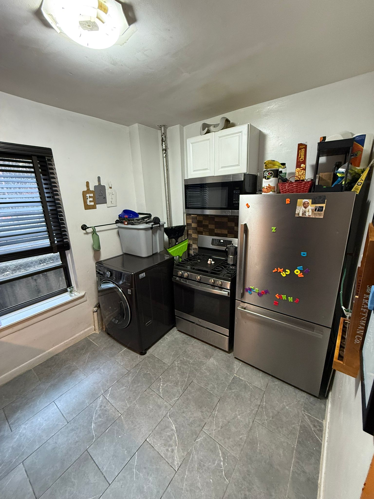 883 East 165th Street, Unit 1F Bronx, NY 10459 - Photo 7 of 7 a kitchen with refrigerator and stove