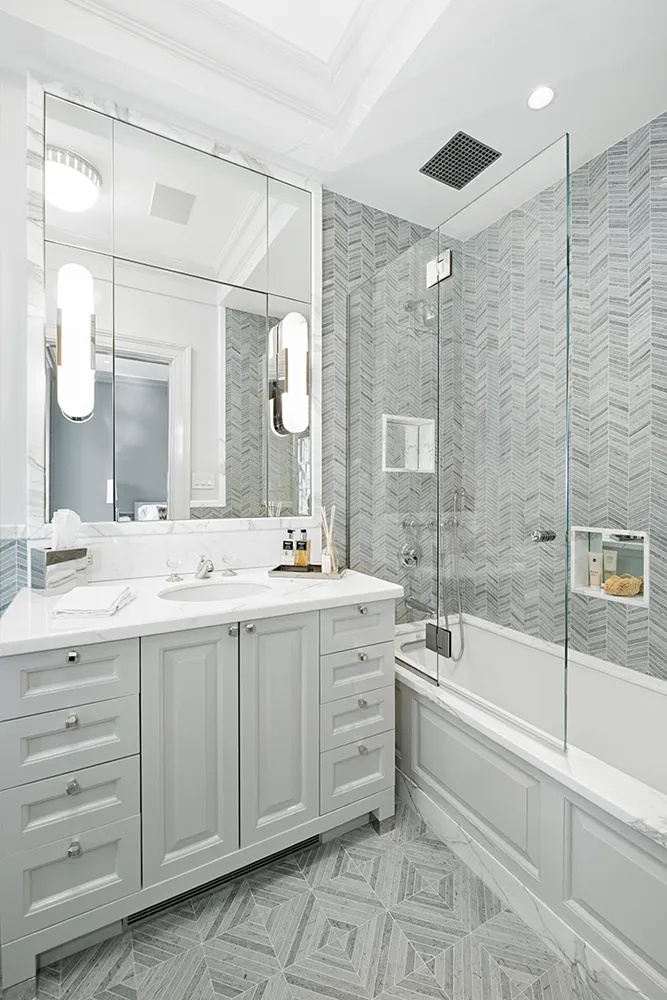 a bathroom with a double vanity sink a toilet and shower