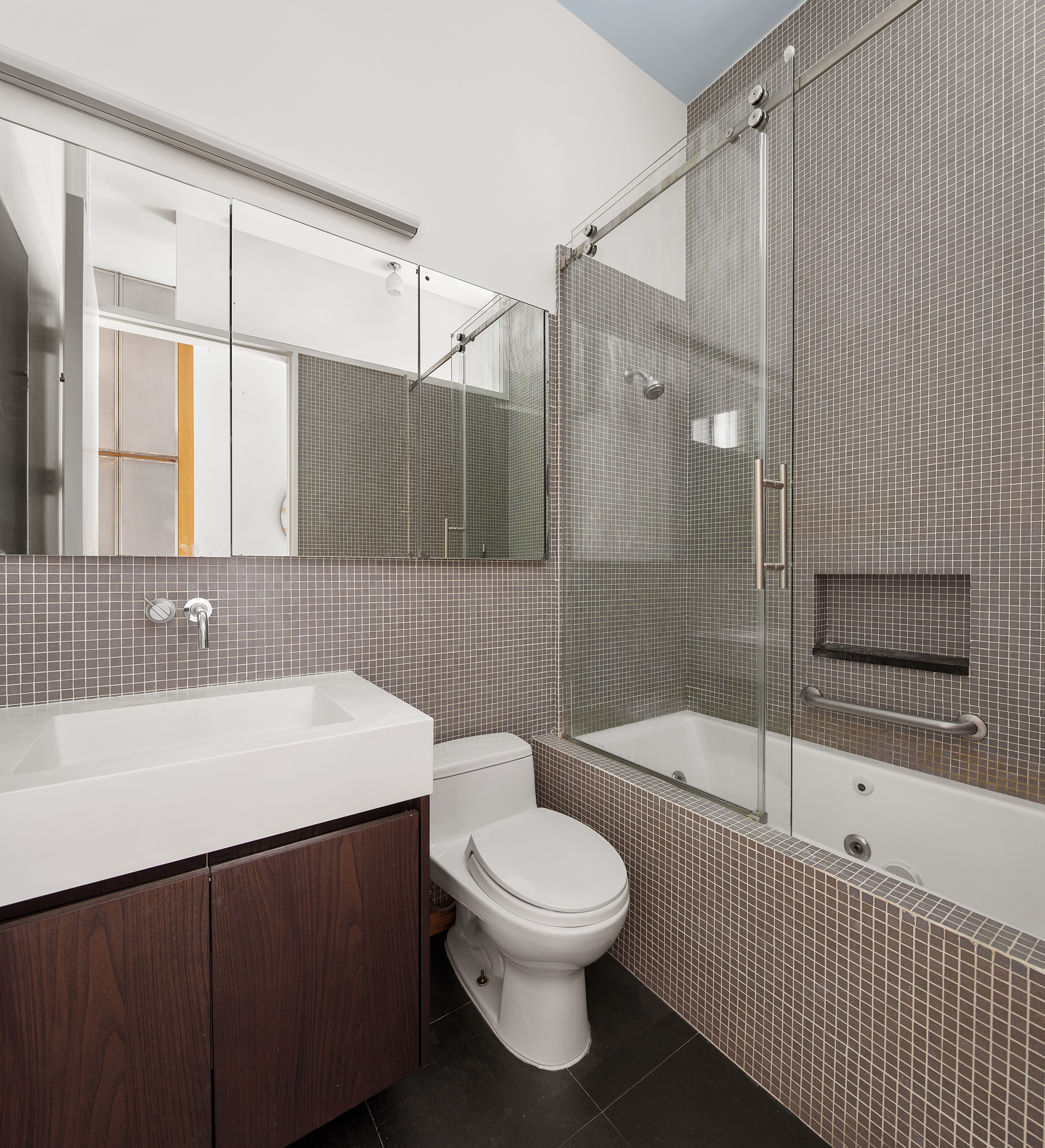 84 Mercer Street, Unit 3E Manhattan, NY 10012 - Photo 16 of 19 a bathroom with a sink a toilet and shower