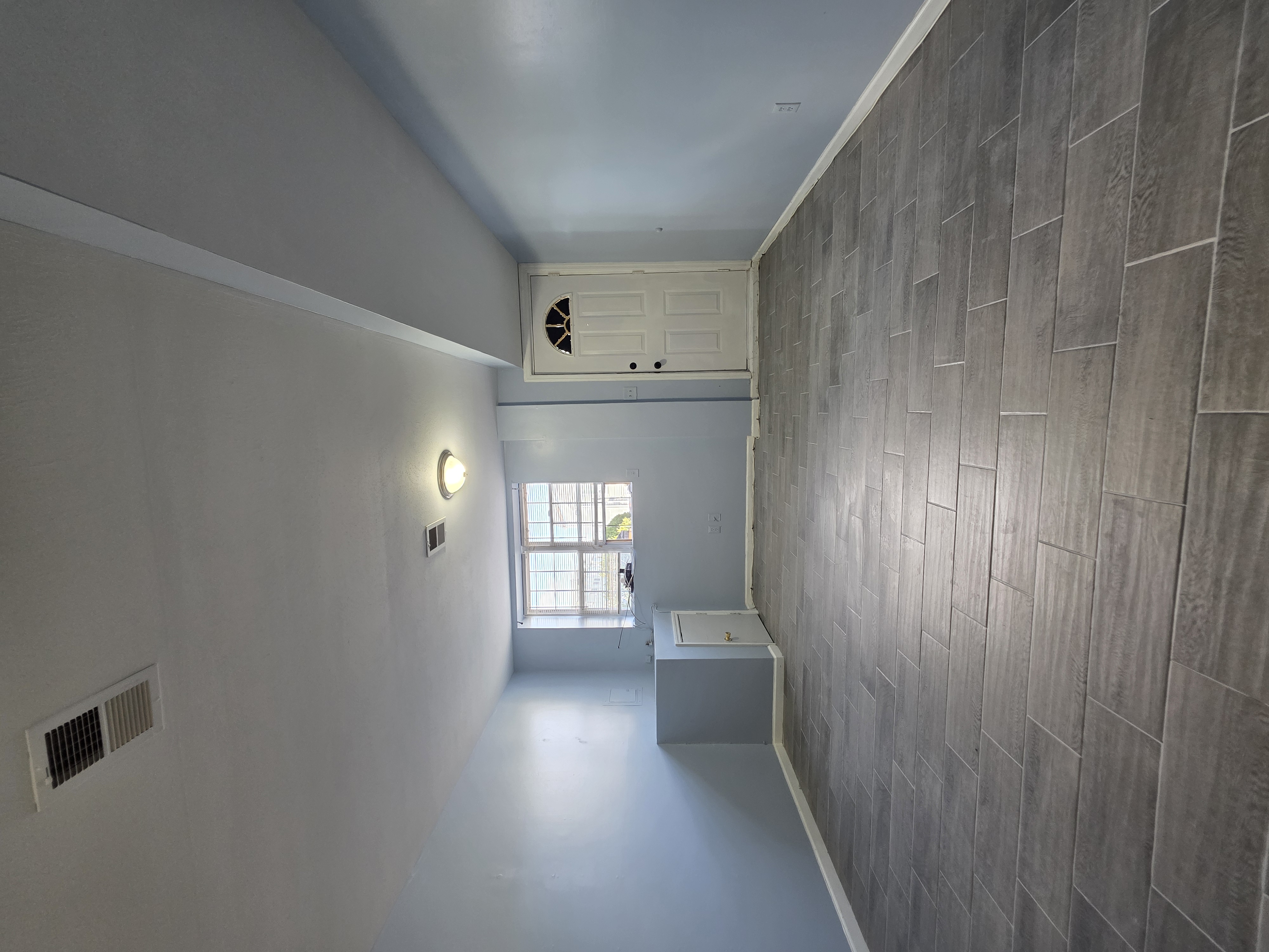 216 Pond Way, Unit 1 Staten Island, NY 10303 - Photo 2 of 9 a view of an empty room with a window