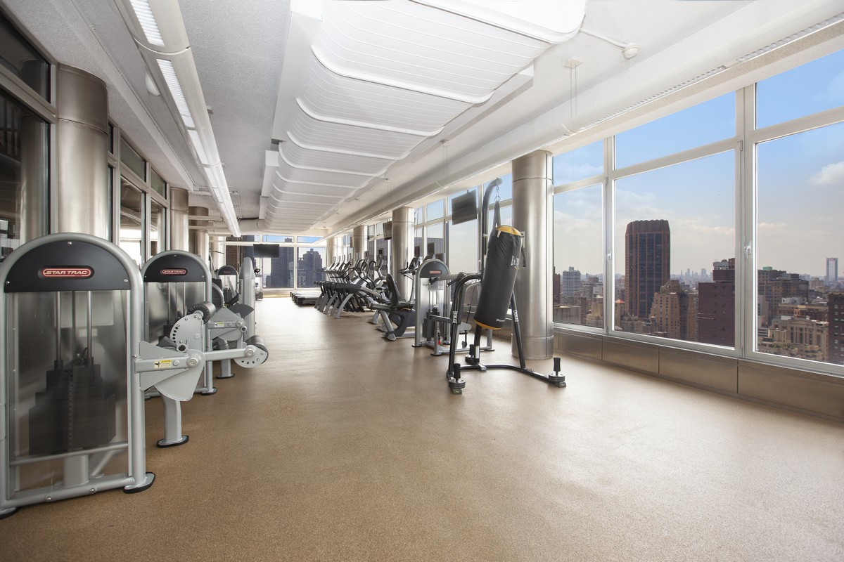 445 5th Avenue, Unit 23D Manhattan, NY 10016 - Photo 11 of 15 a lobby with furniture and floor to ceiling window