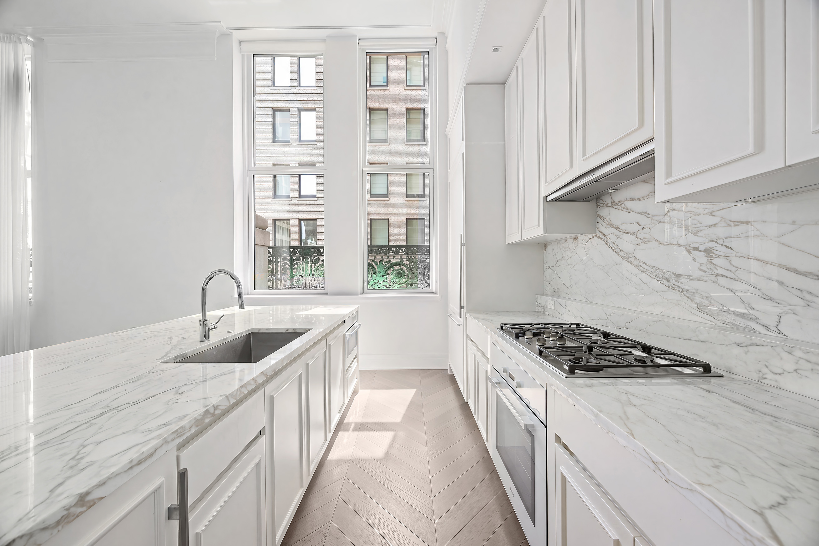 108 Leonard Street, Unit 5A Manhattan, NY 10013 - Photo 4 of 21 a kitchen with granite countertop a sink and cabinets