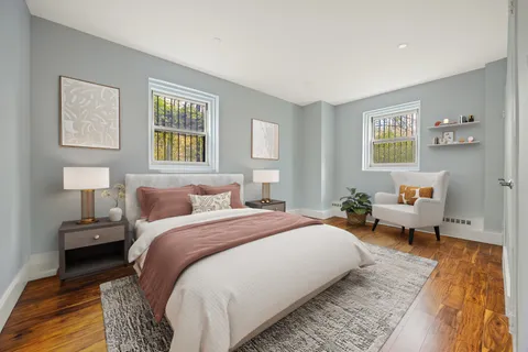 a bedroom with a bed and wooden floor