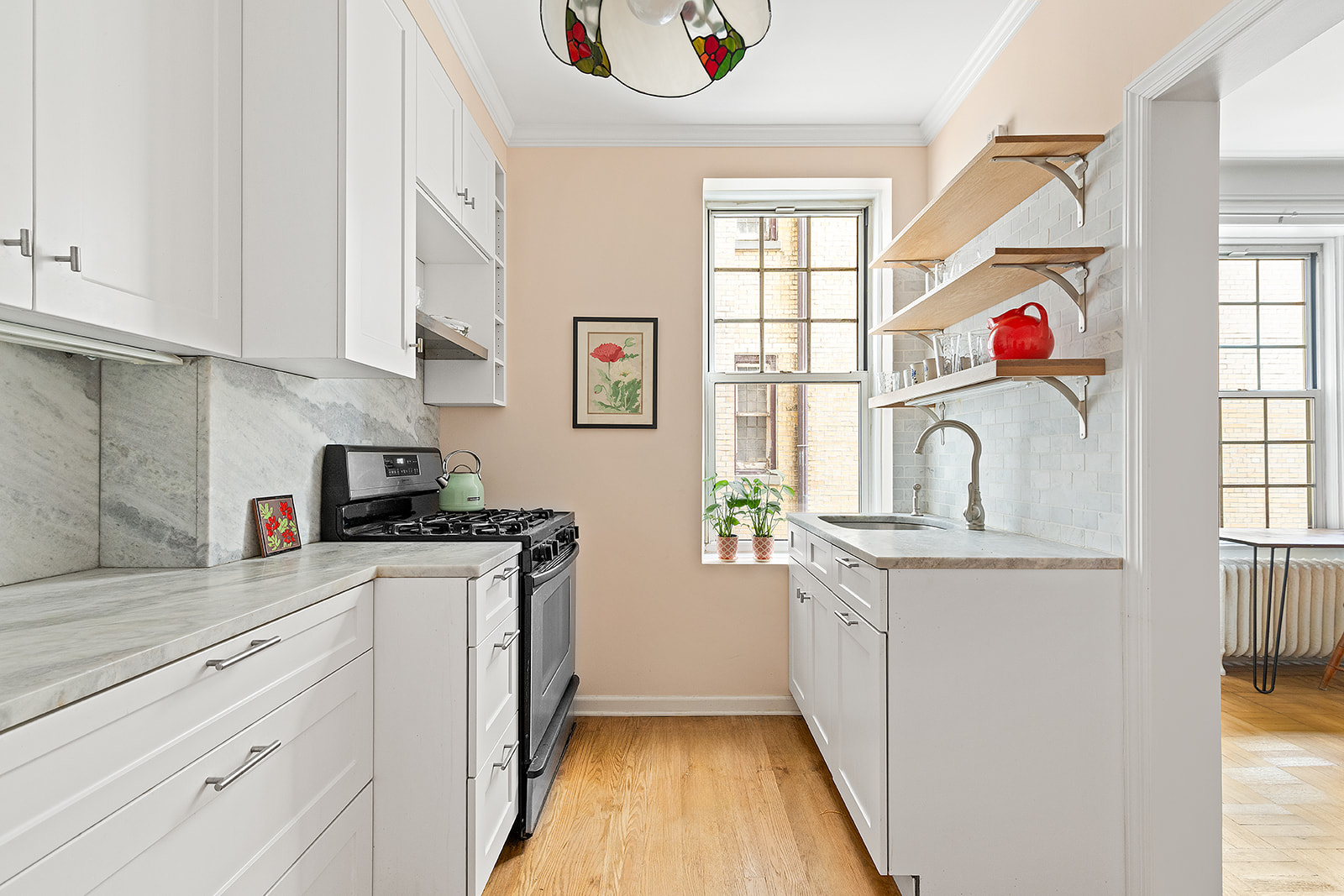 125 Prospect Park West, Unit 2E Brooklyn, NY 11215 - Photo 6 of 9 a kitchen with stainless steel appliances granite countertop a stove and a window