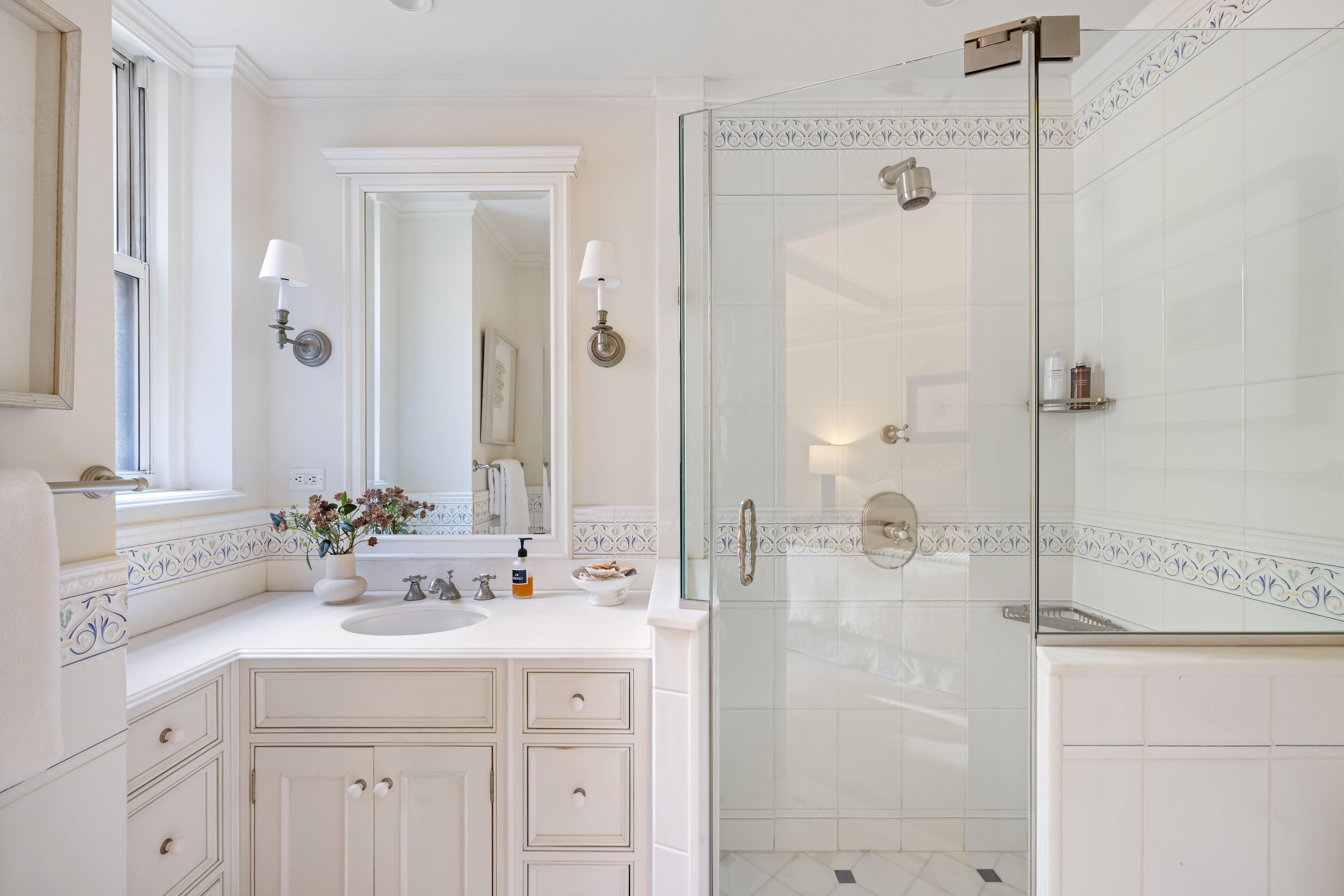 320 East 72nd Street, Unit 5B Manhattan, NY 10021 - Photo 11 of 18 a bathroom with a double vanity sink mirror and shower