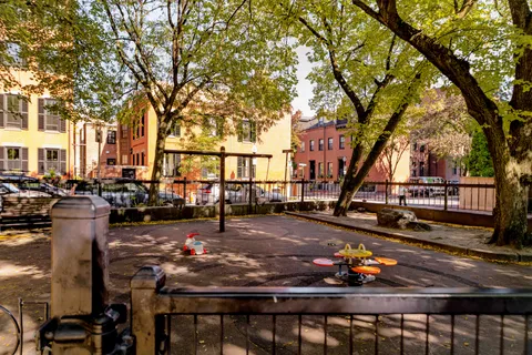 a view of a patio with table and chairs and wooden fence
