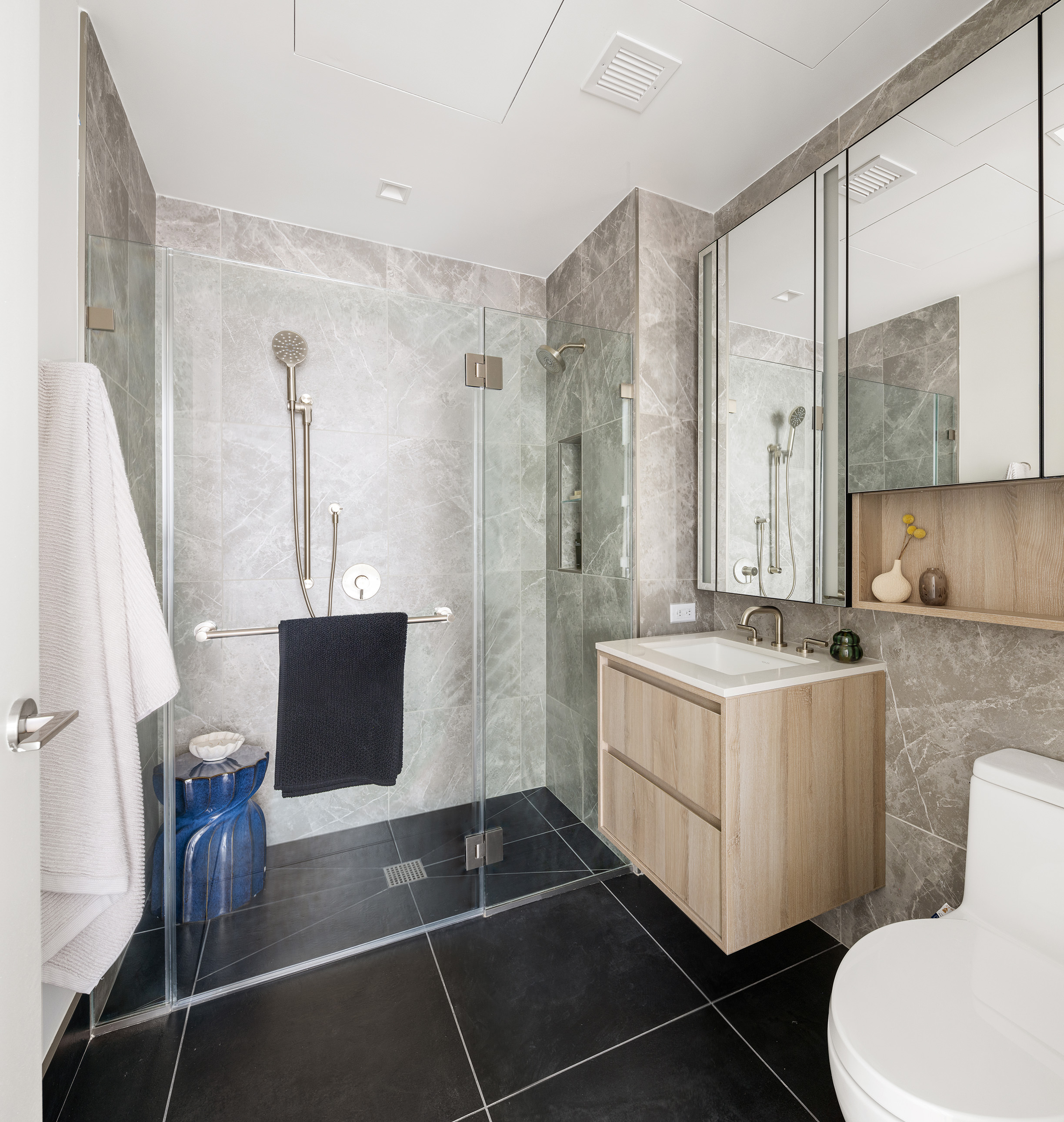 312 West 43rd Street, Unit PHB Manhattan, NY 10036 - Photo 5 of 12 a bathroom with a double vanity sink toilet and shower