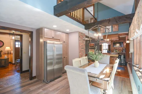 a view of a dining room with furniture wooden floor and a chandelier